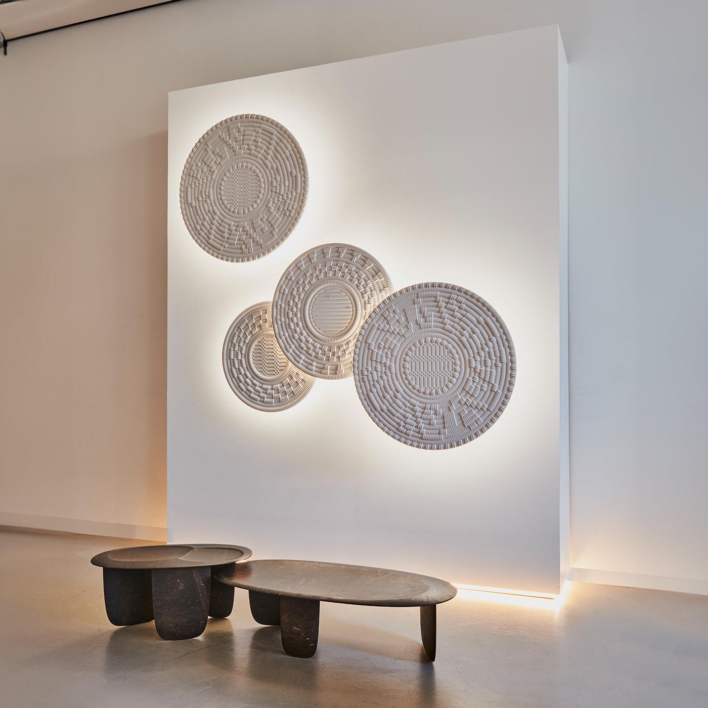 SESI A - coffee table in Brown Stone Small is a stone table recognizable by the unique curved lines which resemble the pebbles marked by the seawater, placed one on top of the other, like balancing building blocks on the seashore. It is named after