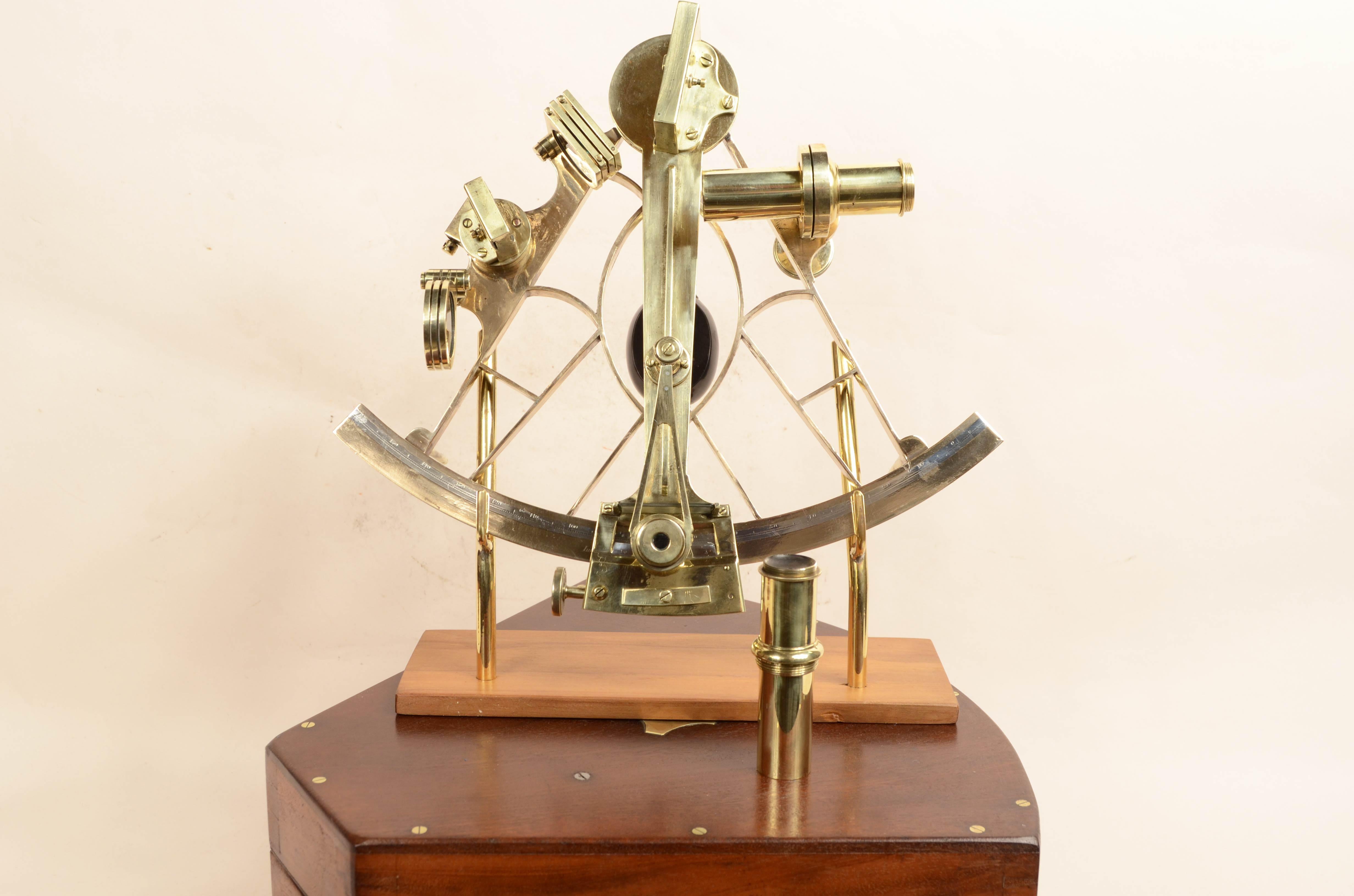 Brass sextant signed Imray & Son 89 & 102 Minories London, datable to around mid-19th century, instrument housed in its original mahogany box shaped like the instrument with hinges, brass locking hooks. Brass frame with engraved silver goniometric