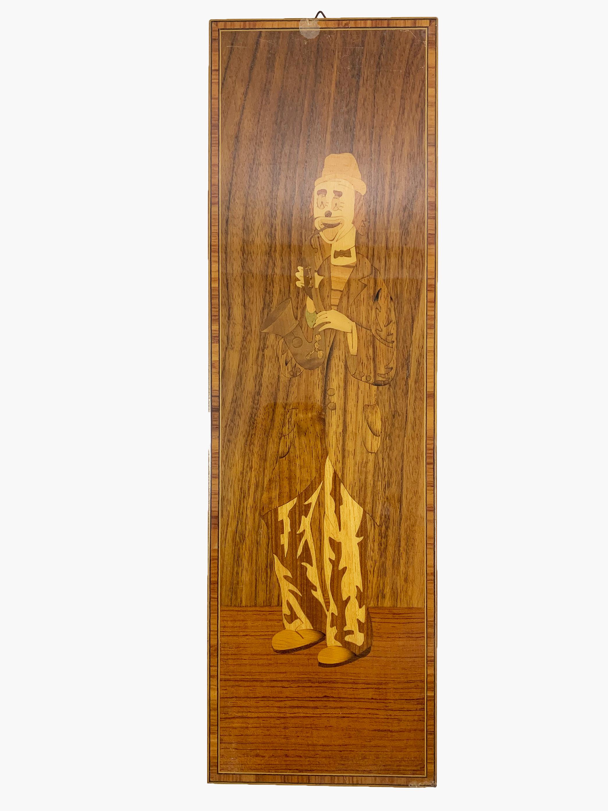 The set of three wood inlay panels intricately depicts a trio of musician clowns, each masterfully crafted with precision and artistry.

The first panel captures the essence of musical whimsy with a clown playing the saxophone, his posture animated