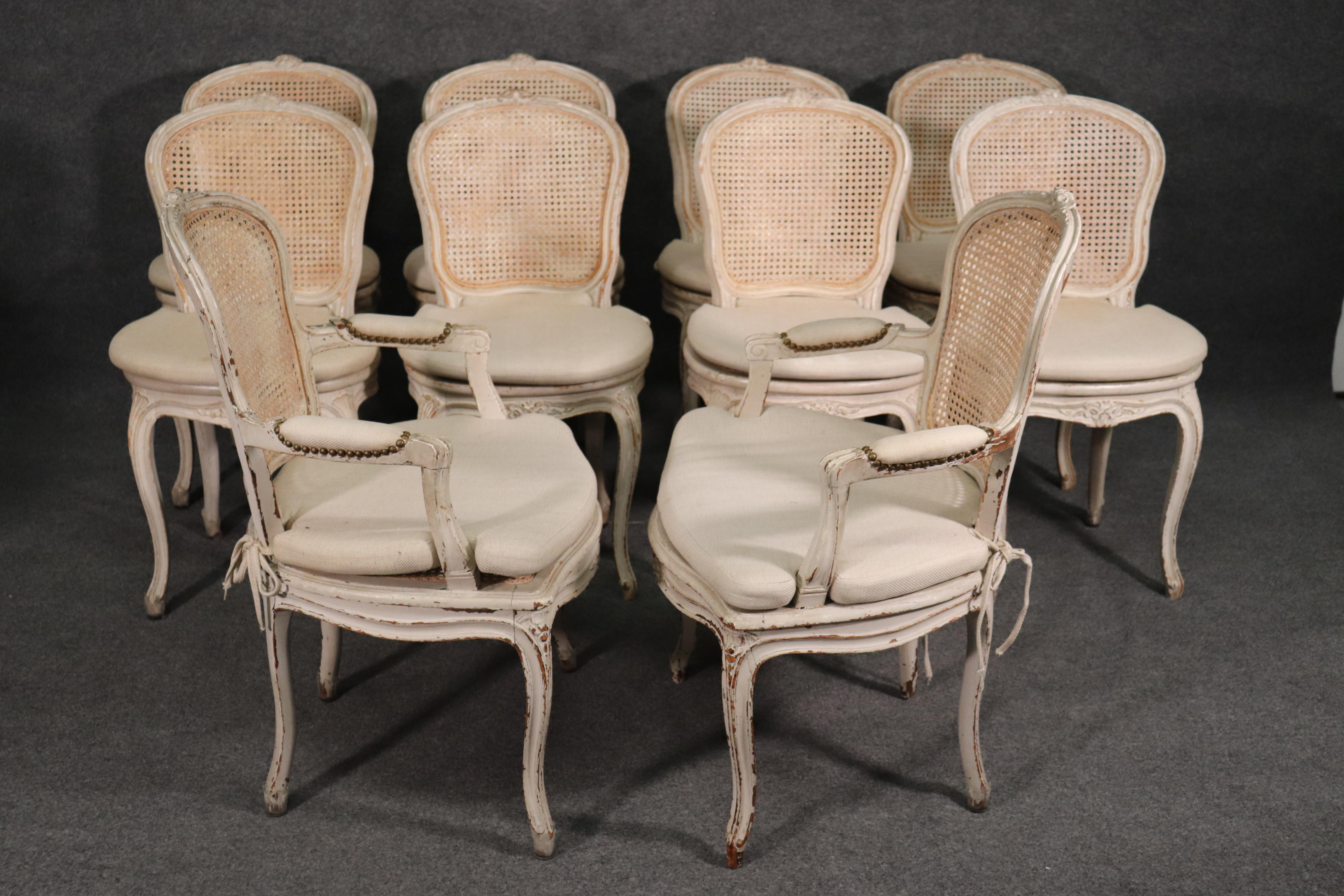 This is a fine set of absolutely gorgeous Maison Jansen chairs. Nine of the ten have no damage to the cane seats or backs, but one of the seats does have a small puncture which is shown. These are classic dining chairs in good antique condition.