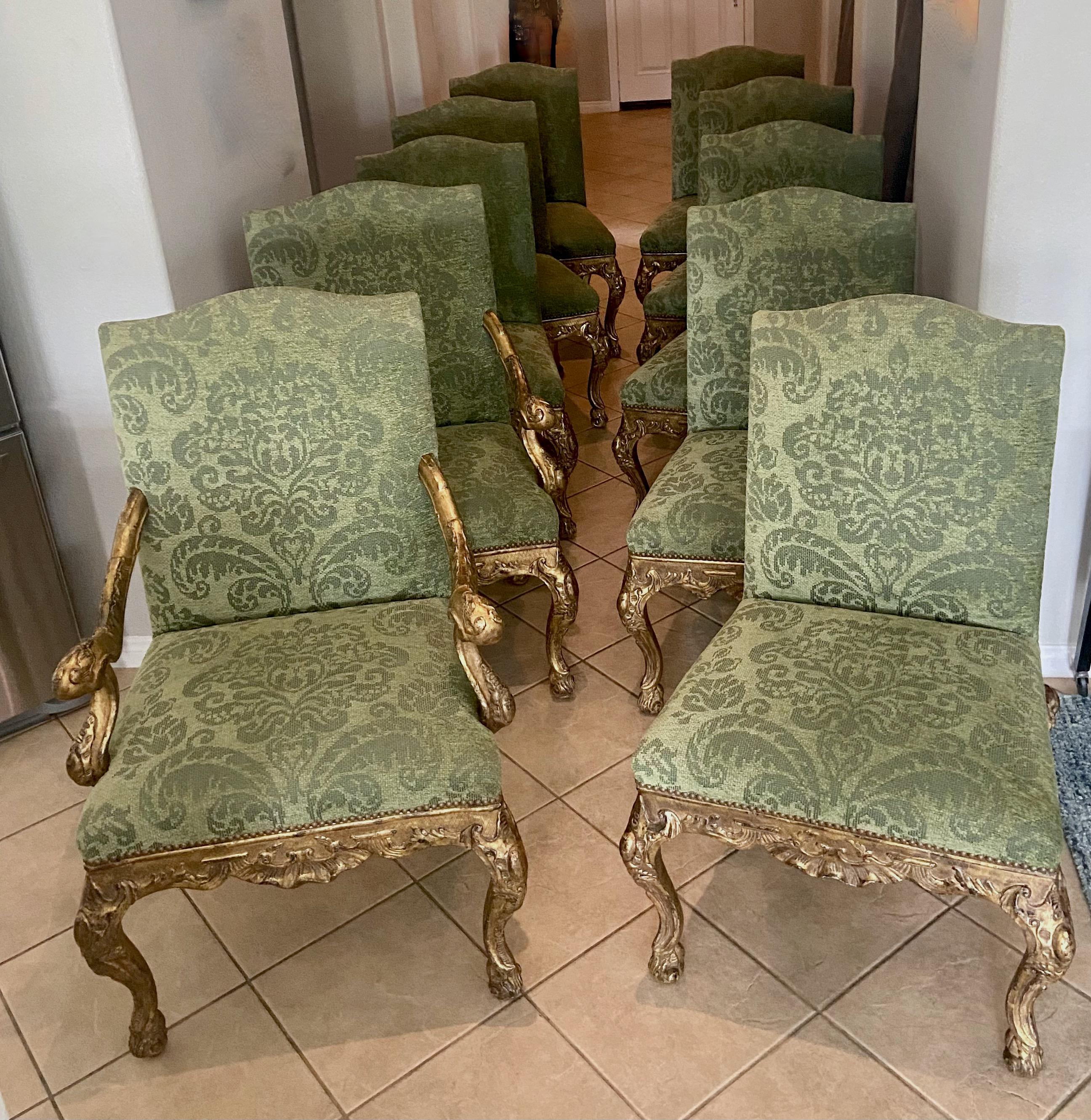 Striking set of 10 (ten) French XV style carved giltwood dinning chairs. Set includes 2 thrown style arm chairs and 8 upright armless chairs. Each chair expertly carved using quality hard wood, the gilt gesso finish has been aged to look as 18th