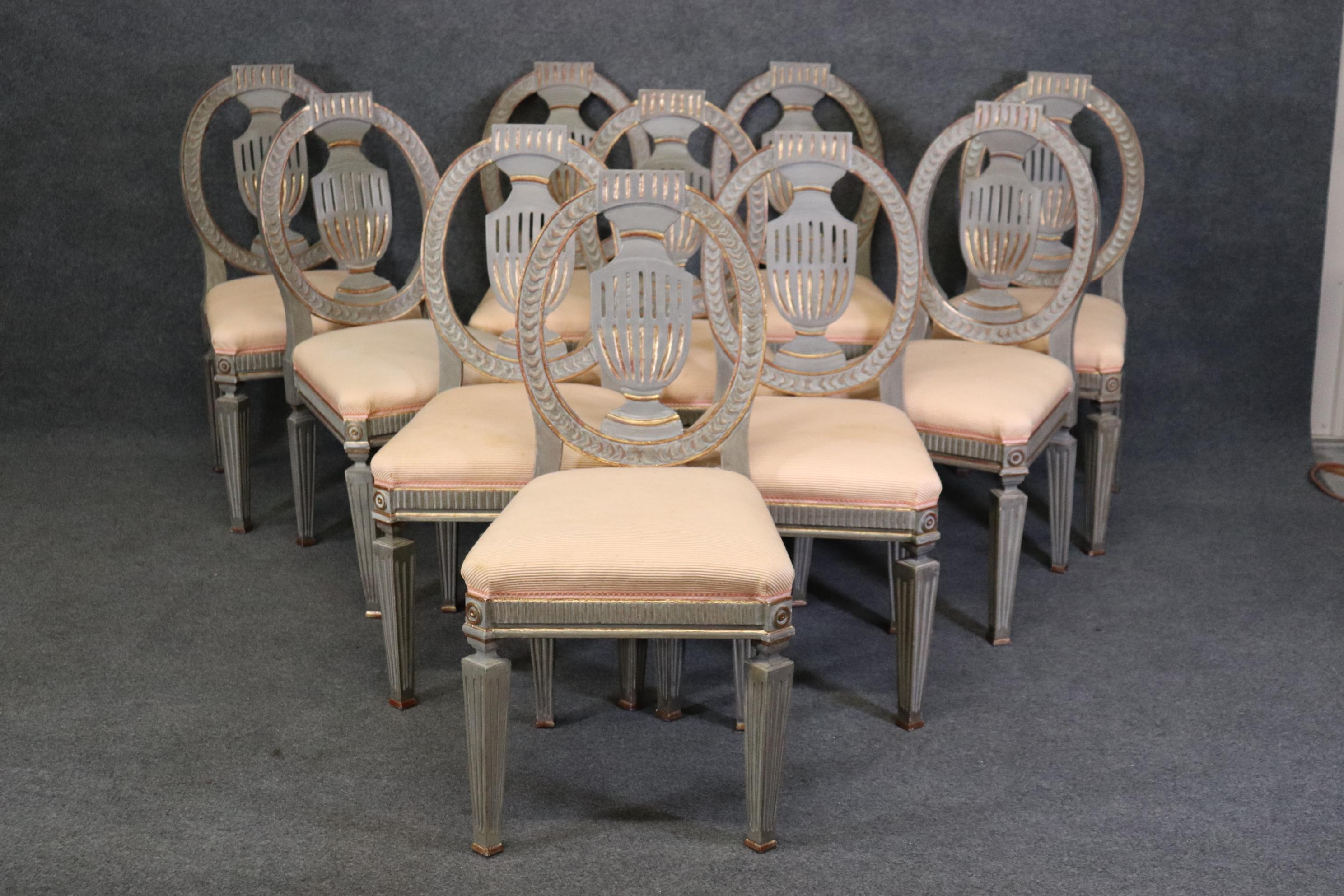 This is a fantastic set of 10 gray paint decorated and gilded Swedish or Gustavian dining chairs. they are authentic Swedish chairs and have gorgeous coloration and fine gilded details and robust design quality. The chairs are in good condition and