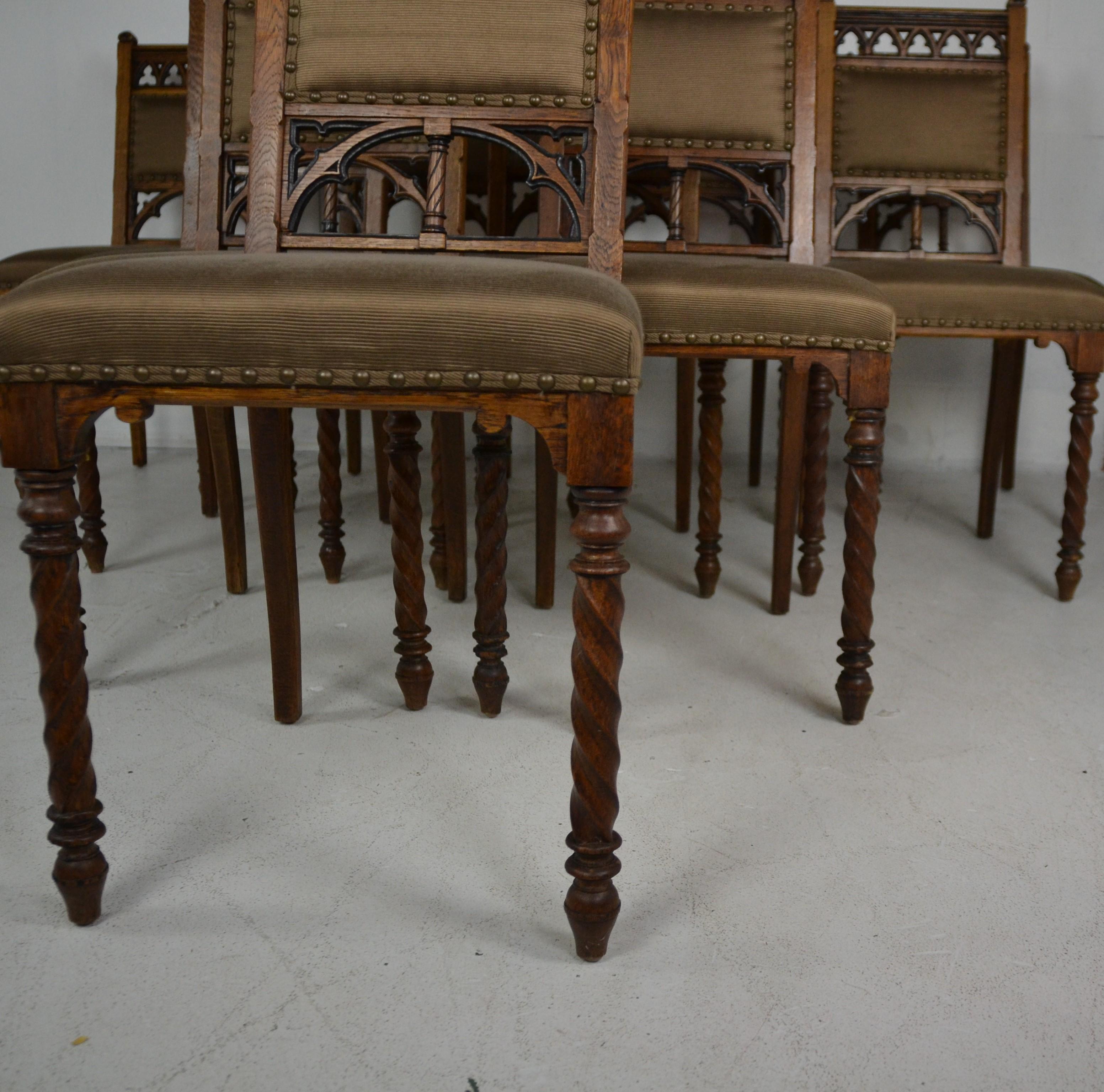 Oakwood carved gothic style set of 10 dining chairs. Brown color upholstery one chair has minor stain.