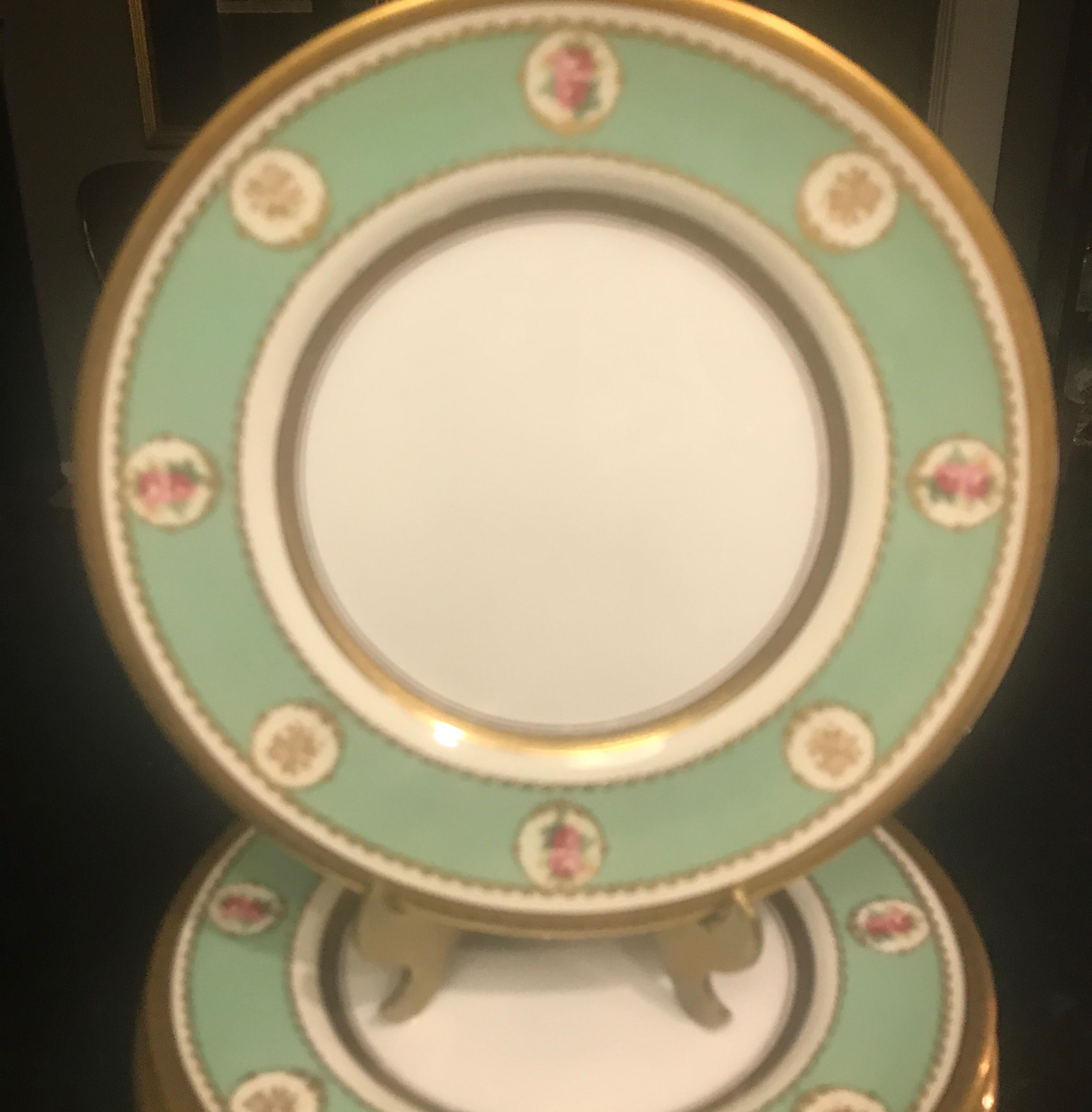 Elegant set of English 9” accent plates by the best royal fountain decorator Herbert Betteley. The apple green borders with gilt rims and inner circle with hand painted floral cartouches.