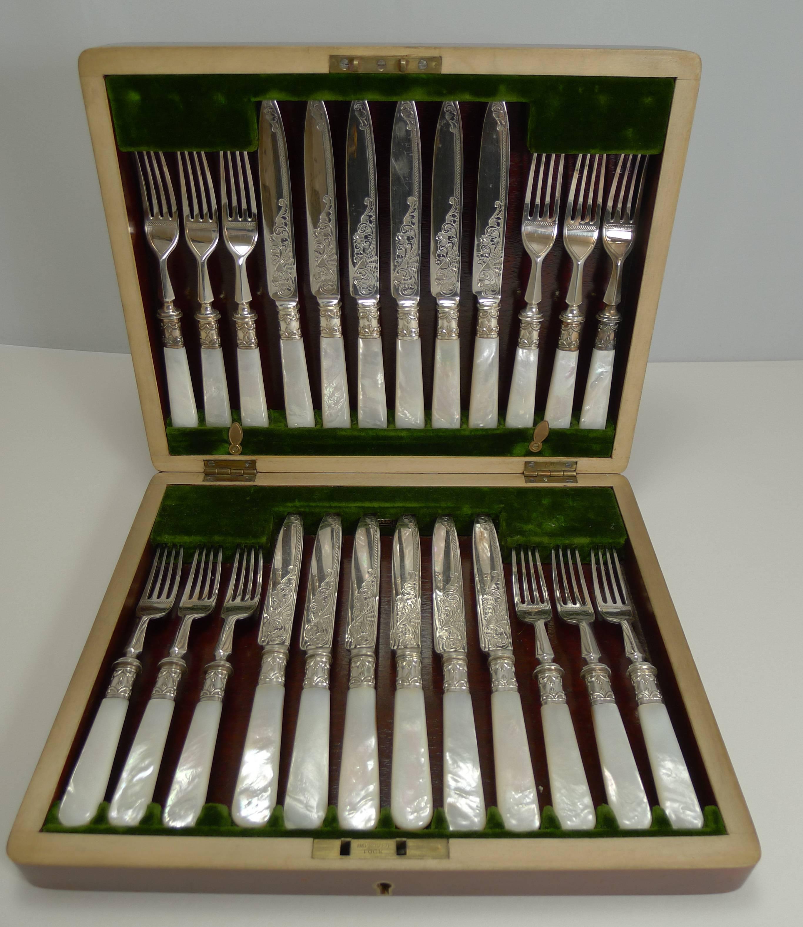 An absolutely sensational and highly decorative complete boxed set of twelve fruit or desert knives and forks, rarely found in such lovely condition. The knives are all fully marked with the silversmith's initials J.M.C & S.

Each knife and fork