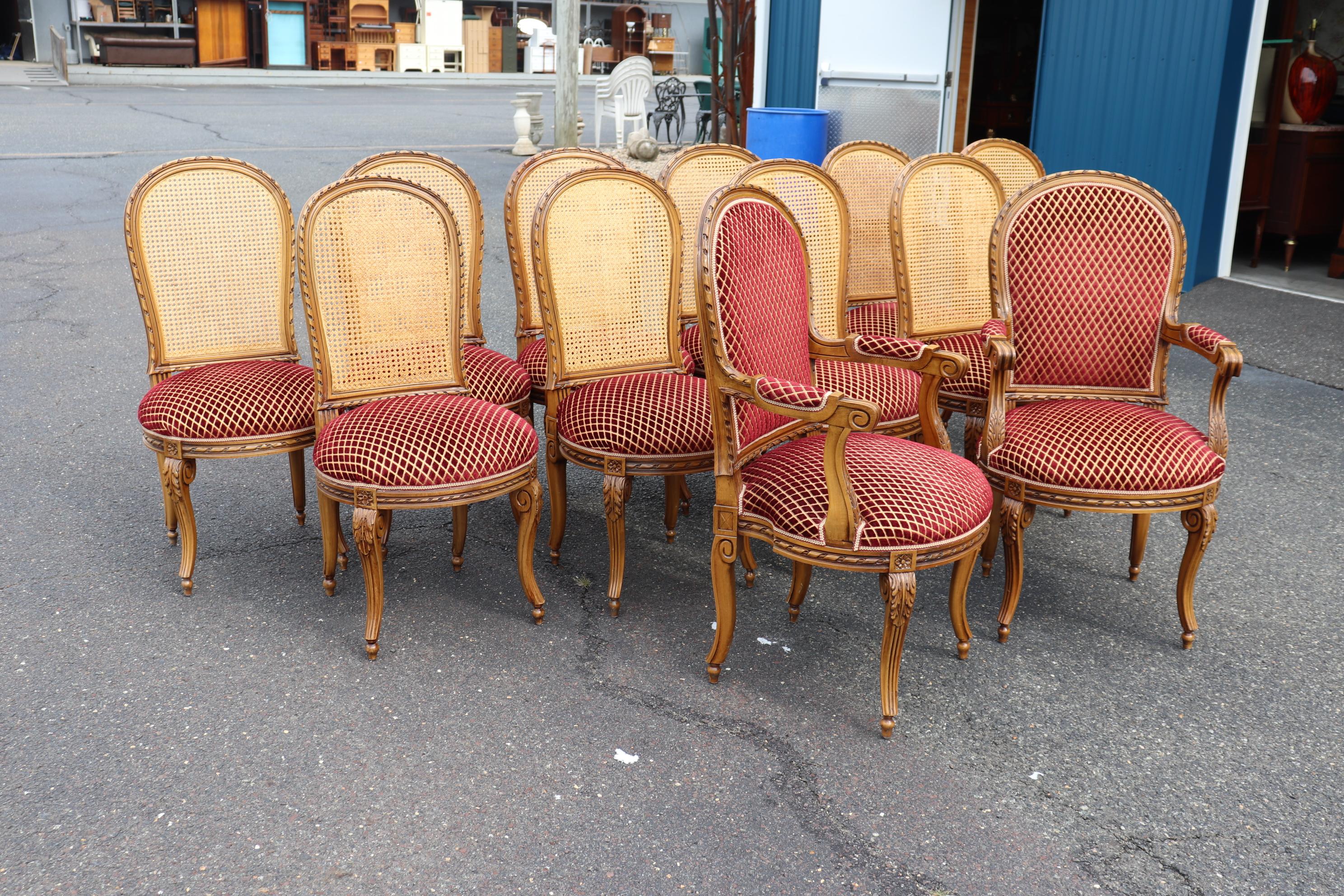 This is a fantastic set of 12 dining chairs in excellent condition. They have new caned backs and no damage and very good velvet seats in excellent condition. They are comfortable and feature superb carving. They date to teh 1960s era and are
