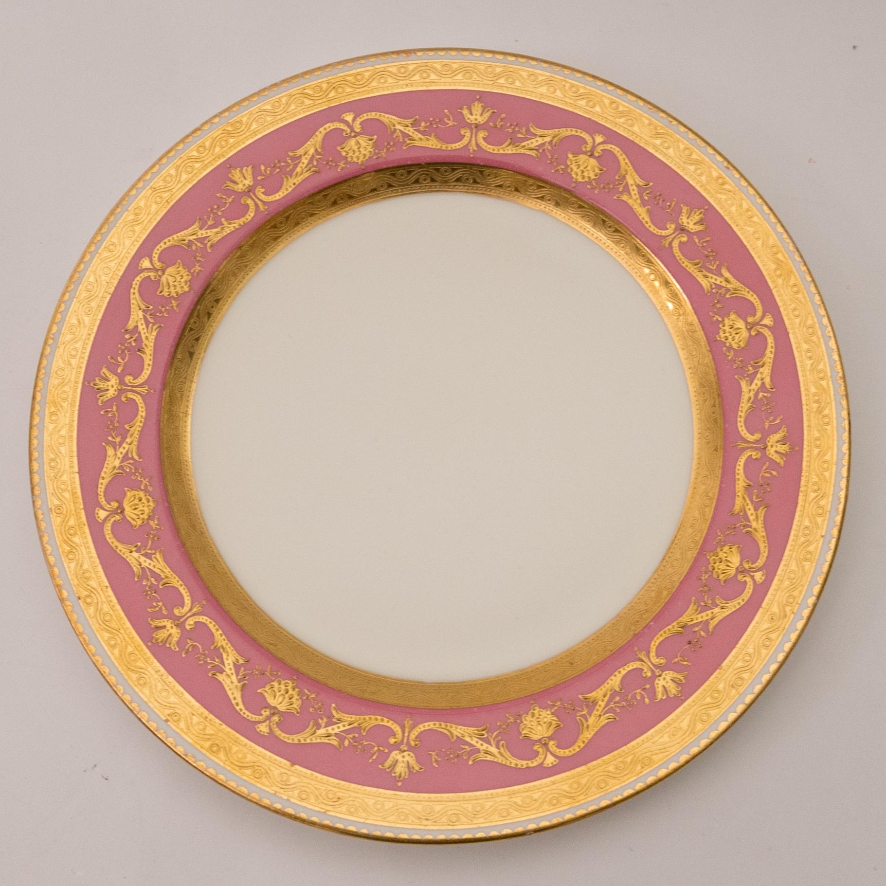 Please see our other listings for a single owner collection of gorgeous pink gilded table top pieces. This set of 12 plates is from the storied firm of Minton's England and features raised tooled gilding on a vibrant pink collar. Custom ordered