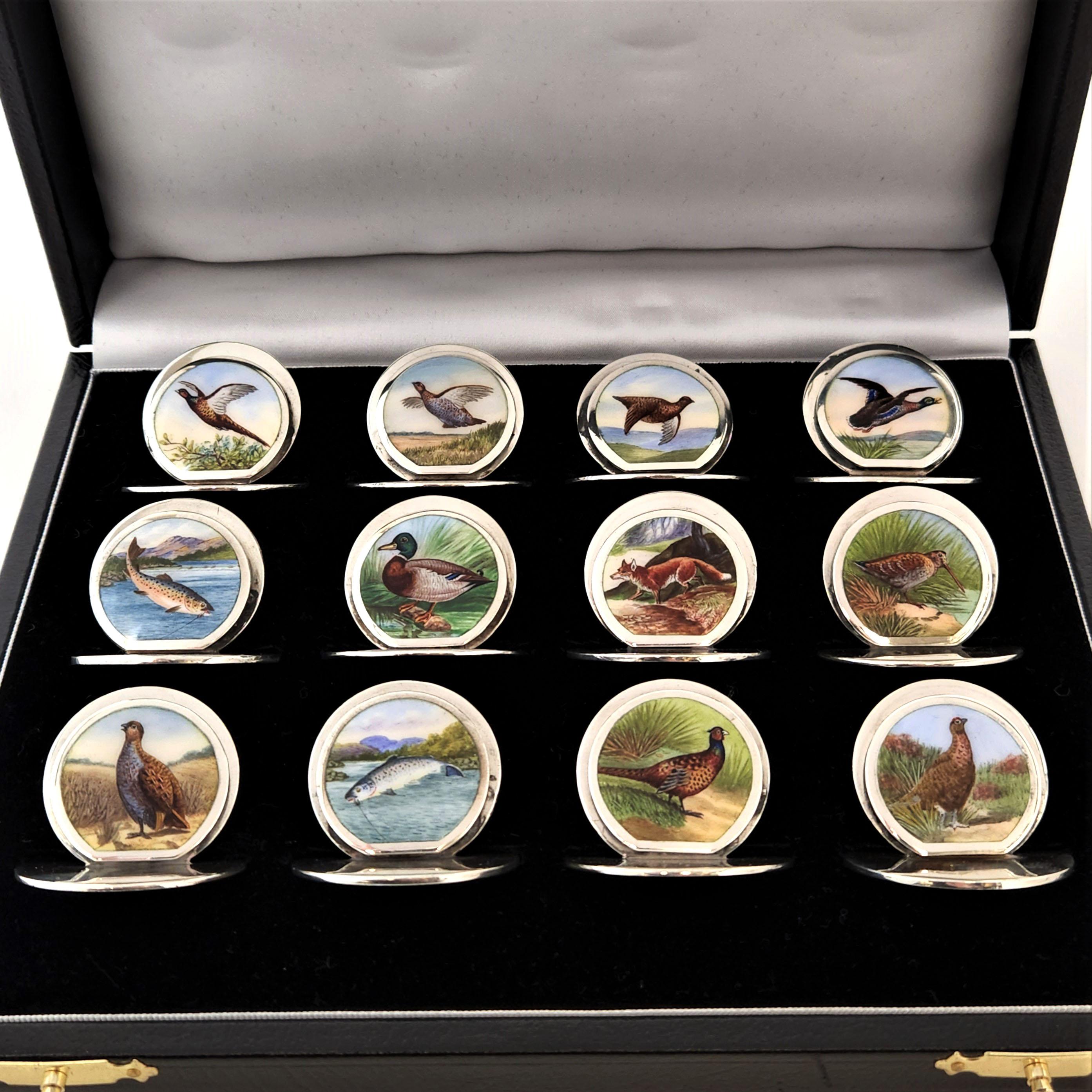 A rare Set of 12 Antique solid Silver & Enamel Place Card Holders / Menu Holders in a black leather fitted case. This set is unusual in that each Name Card Holder has a unique, individual design showing an array of game birds including pheasants,