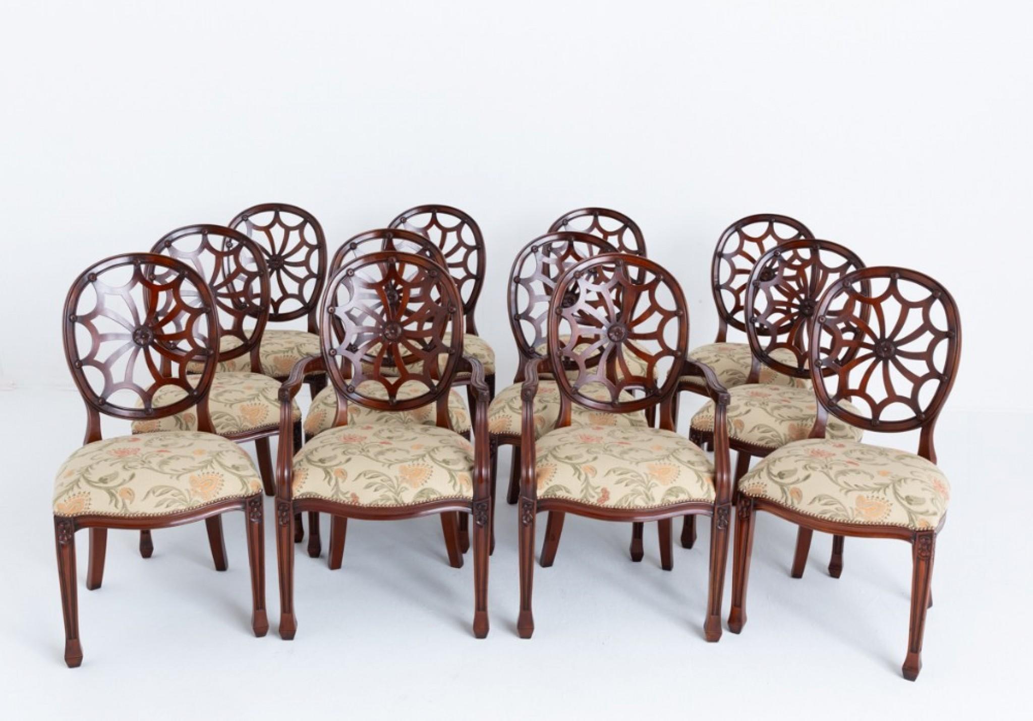 Fabulous set of 12 ( 10 + 2 ) mahogany spider web back dining chairs.
Circa 1900
These chairs are raised upon tapered legs with carved and fluted decoration.
The carvers featuring shaped arm supports with carved rosettes.
The seats being of a stuff