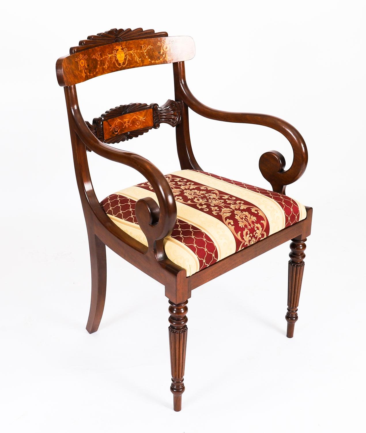 This is a beautiful vintage set of twelve Regency Revival burr walnut dining chairs that comprises ten side chairs and two armchairs.

They are made of solid walnut with fabulous marquetry decoration and are raised on elegant reeded tapering front