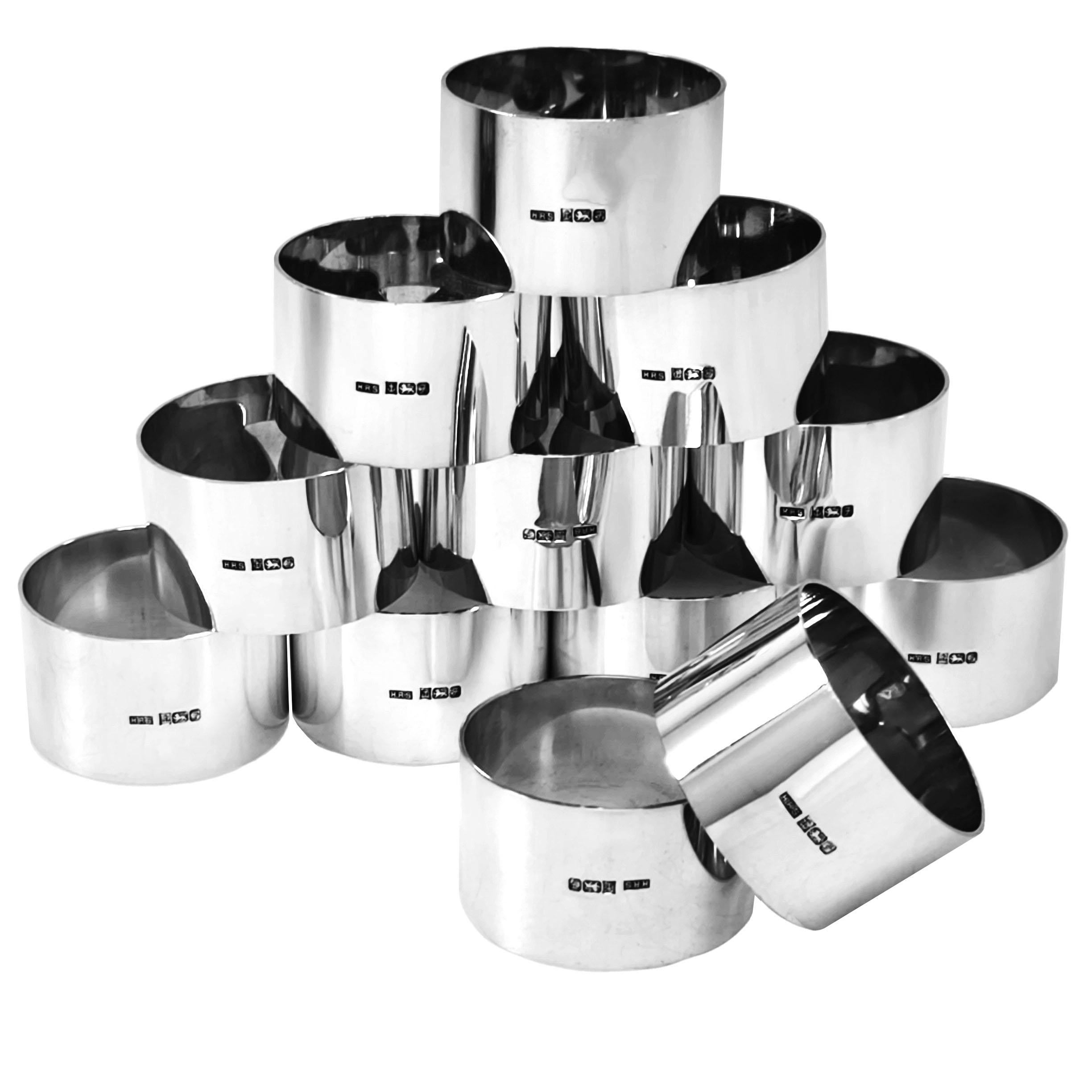 A Set of 12 elegant Sterling Silver Napkin Rings. Each Napkin Ring is understated plain polished Silver with a feature Hallmark on the one side.  These Serviette Rings can be used as is but are suitable for engraving if desired. The Napkin Rings are