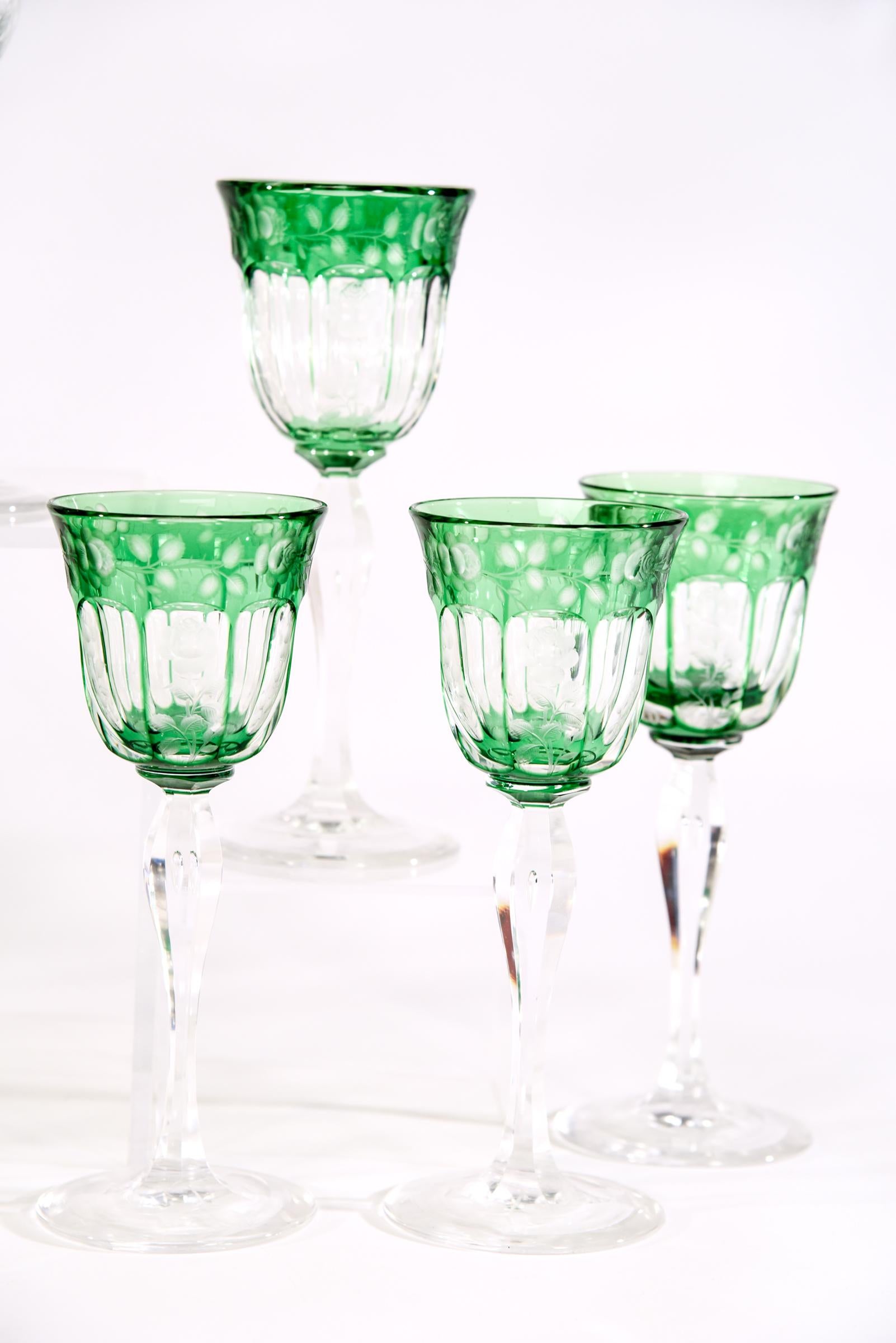 Presenting a magnificent set of 16 hand blown crystal wine goblets with a rich apple green overlay and cut to clear. The fine and detailed engraving of roses surrounding the top border is further embellished with roses in alternating panels