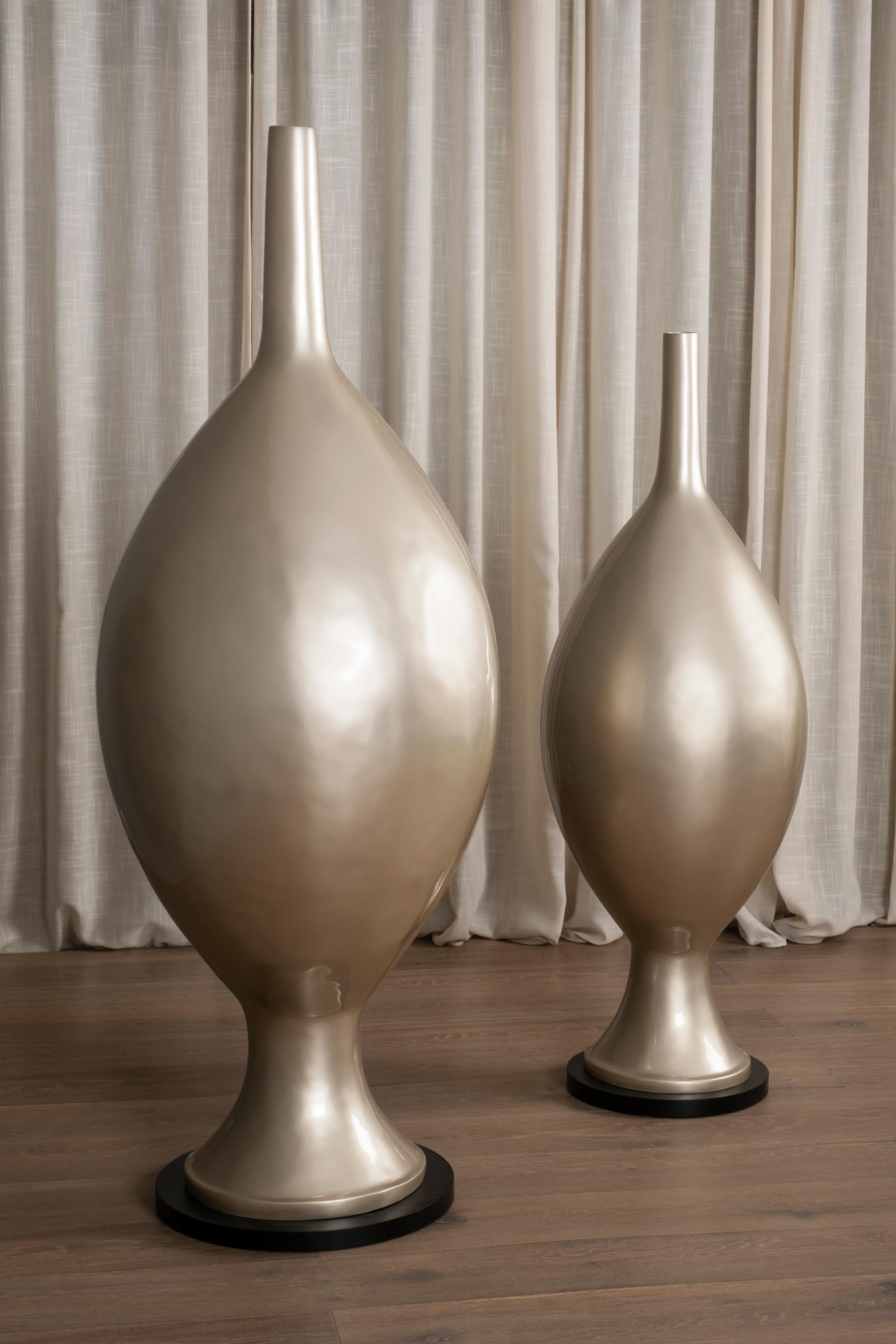 Set of 2 Decorative Floor Vases, Lusitanus Home Collection, by Lusitanus Home.

This beautiful set of two resin floor vases that catches the eye with its champagne elegant silhouette. These floor vases are the perfect decorative choice to enrich any