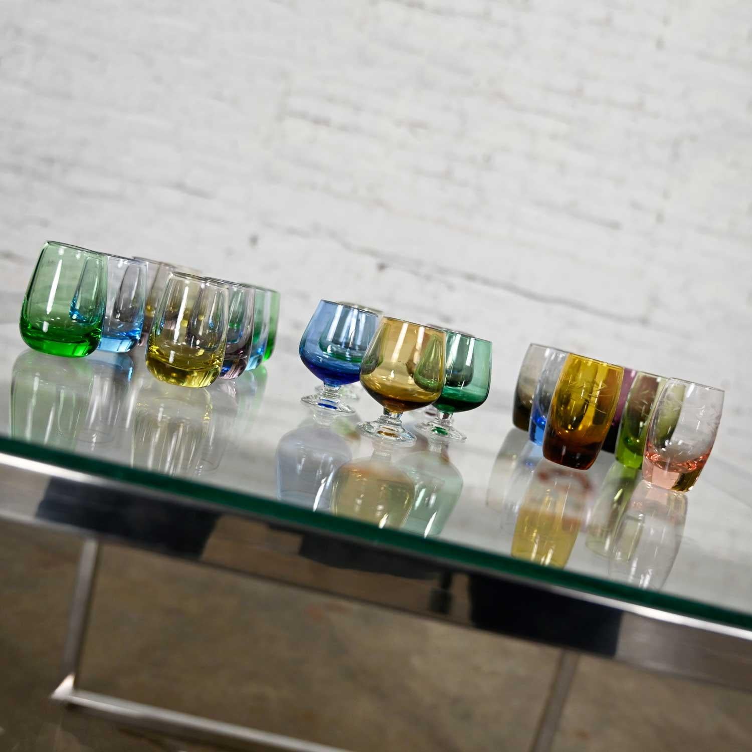 Fabulous vintage set of 21 blown glass multi-colored small cocktail snifters, cordials, or shot glasses in three different sizes. Beautiful condition, keeping in mind that these are vintage and not new so will have signs of use and wear. There is a