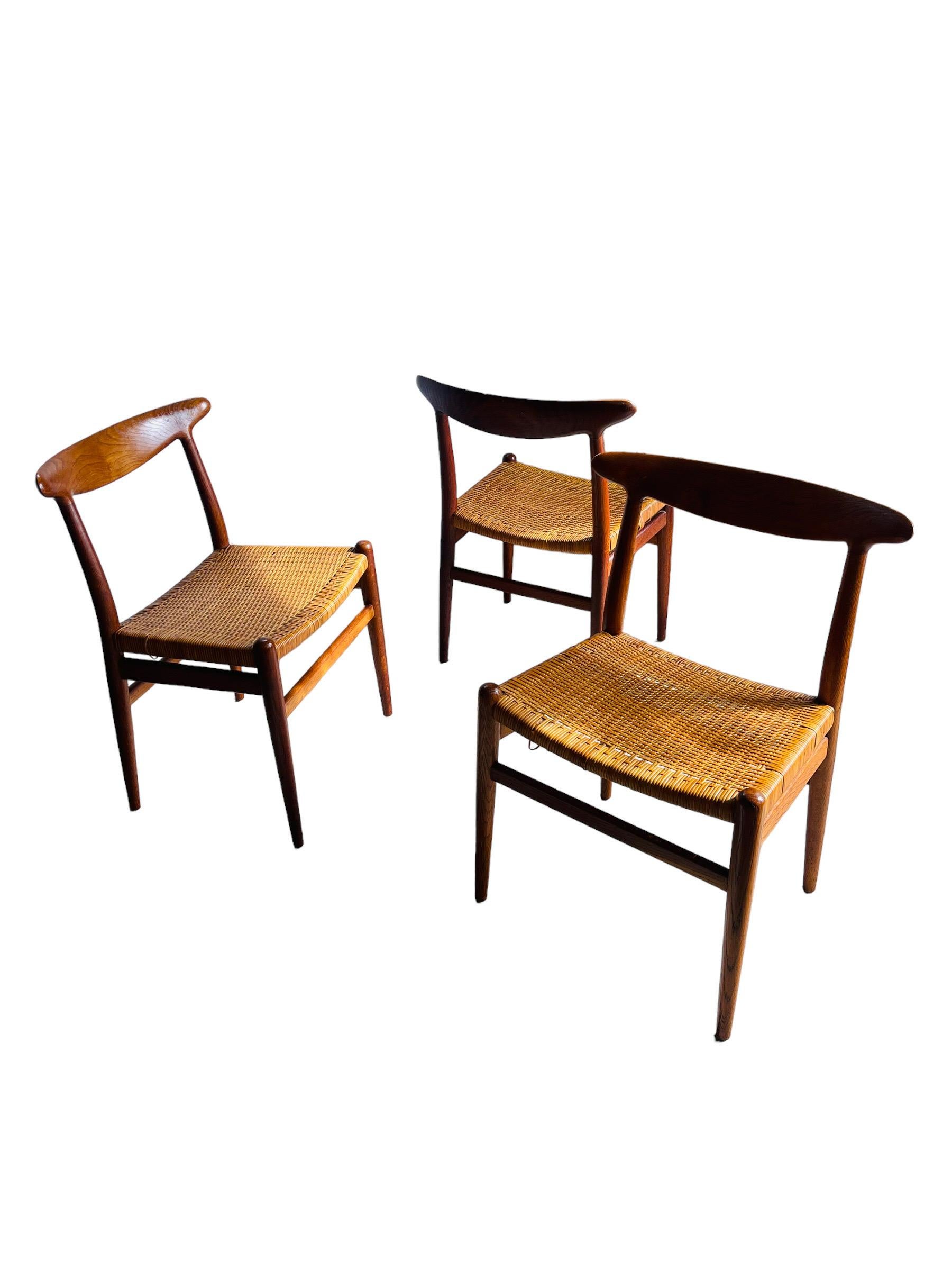 Classic Set of 3 W2 dining chairs by Hans J. Wegner / Denmark, oak and teak construction, stamped C M Madsens. In original vintage condition with patina. 

W 22” x D 15” x H 30” x SH 17”.