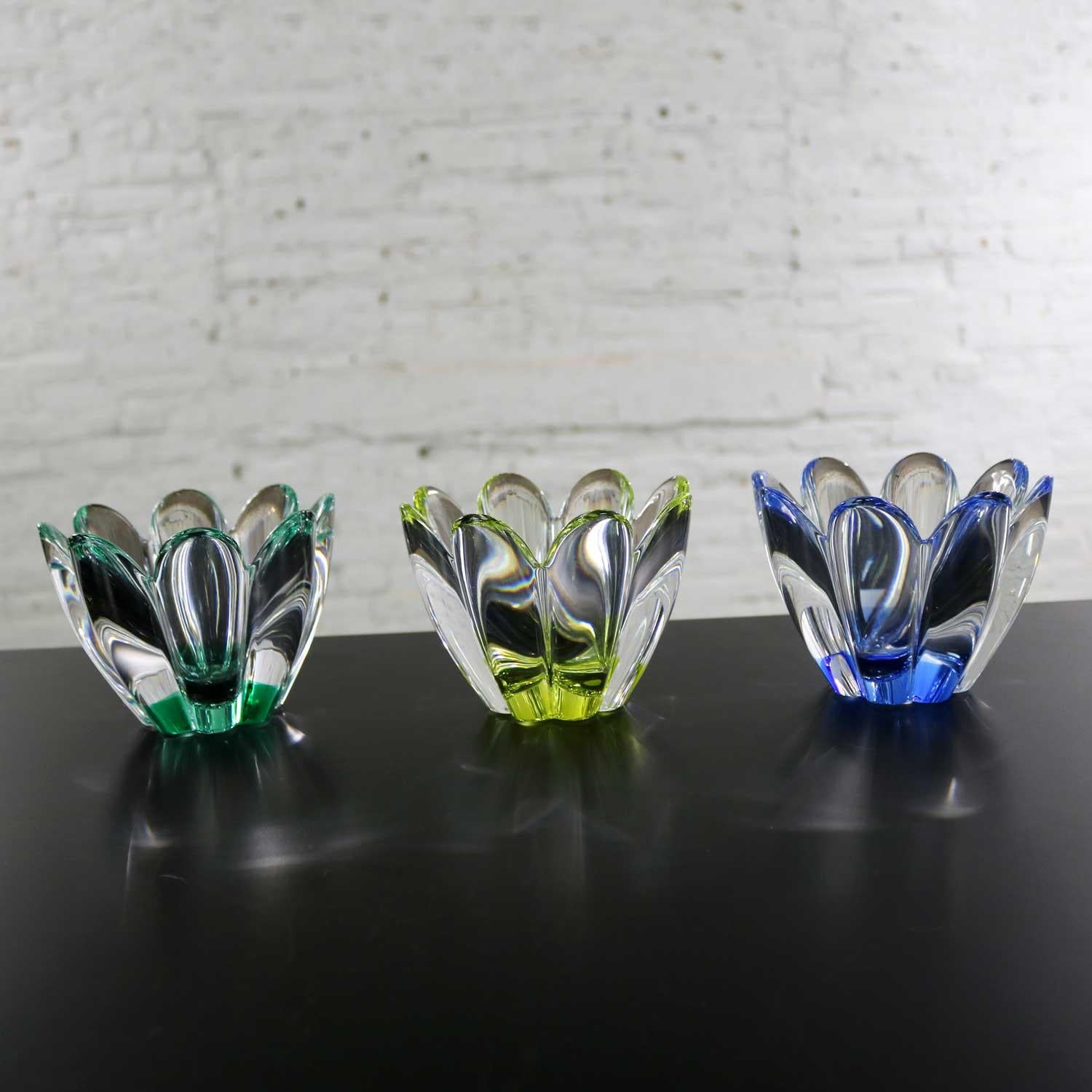Awesome set of 3 vintage Orrefors Sweden glass Mayflower bowls designed by Jan Johansson. There is one each of yellow, green, and blue. These are in excellent new condition signed and still have their original box and tags. We have priced these as a