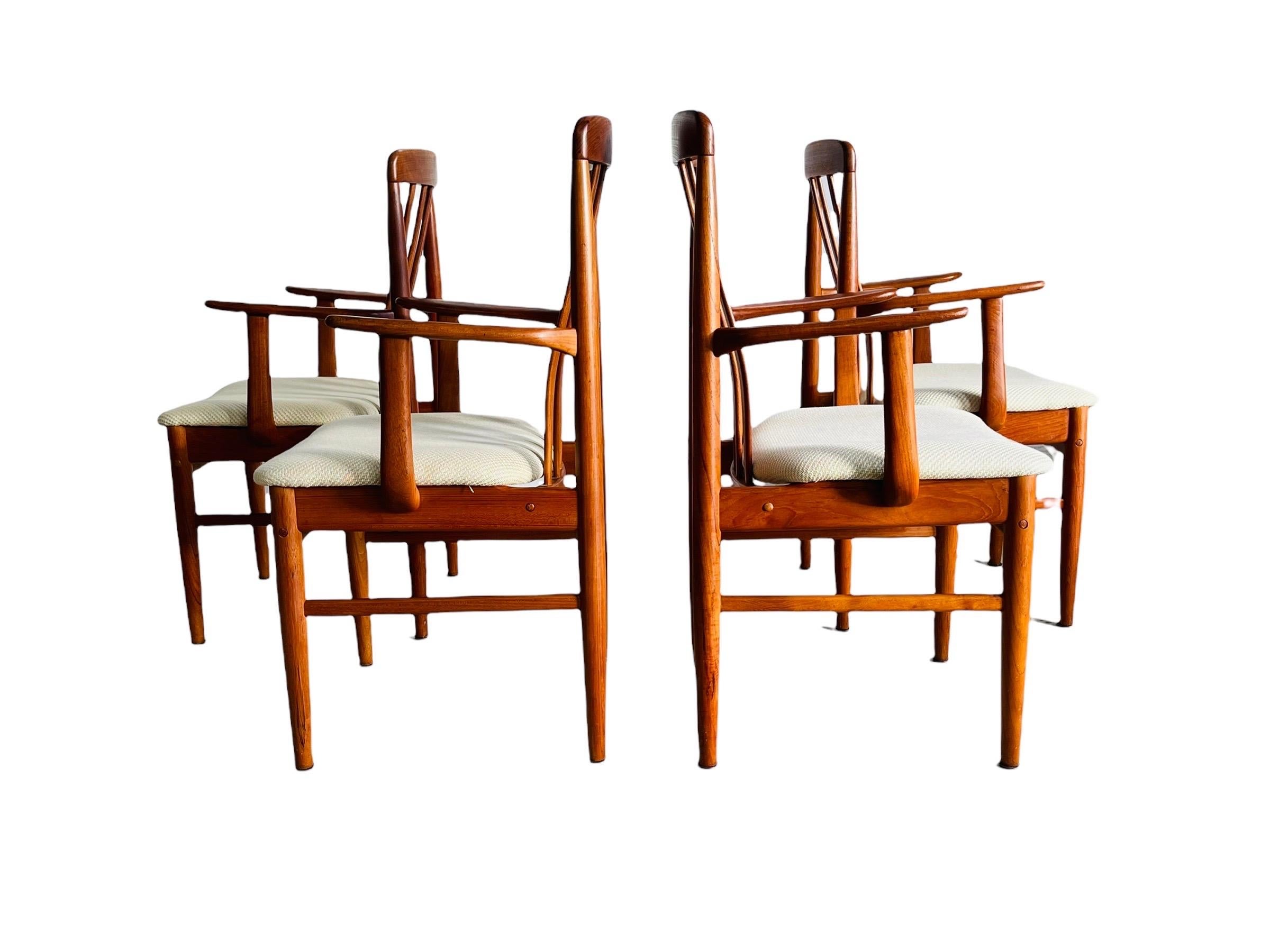 Here is a beautiful set 4 teak dining armchairs newly reupholstered designed by Benny Linden Design. The chairs are all solid and sound. Couple of minor chip to the arms on two chairs but does not effect the integrity of the chair. Chairs are in