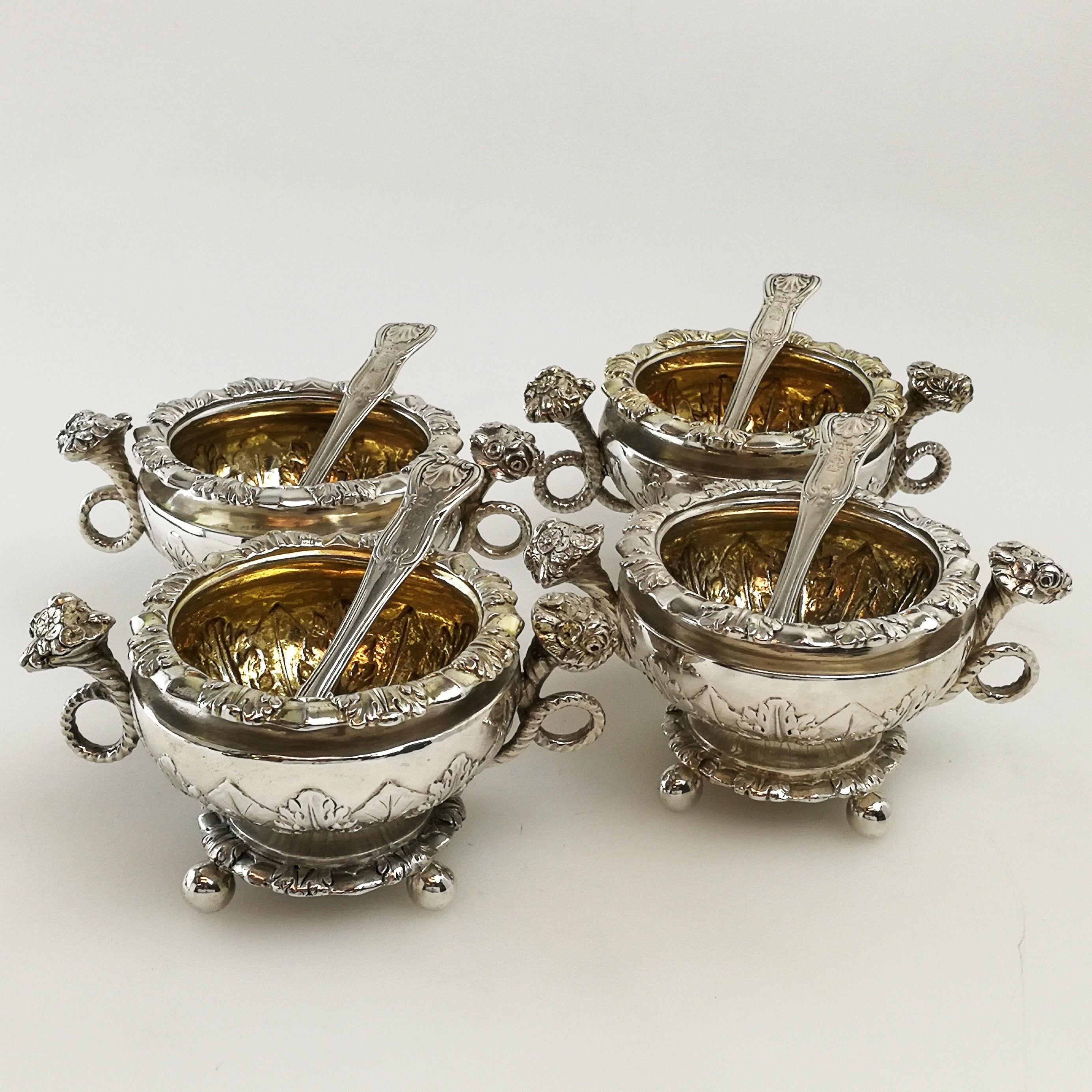 A set of four beautiful Antique Georgian solid Silver Salts. This matched Condiment Set features an elegant chased leaf / foliate design on the body and rim of each Salt. Each salt dish stands on four ball feet and each has a pair of ornate handle