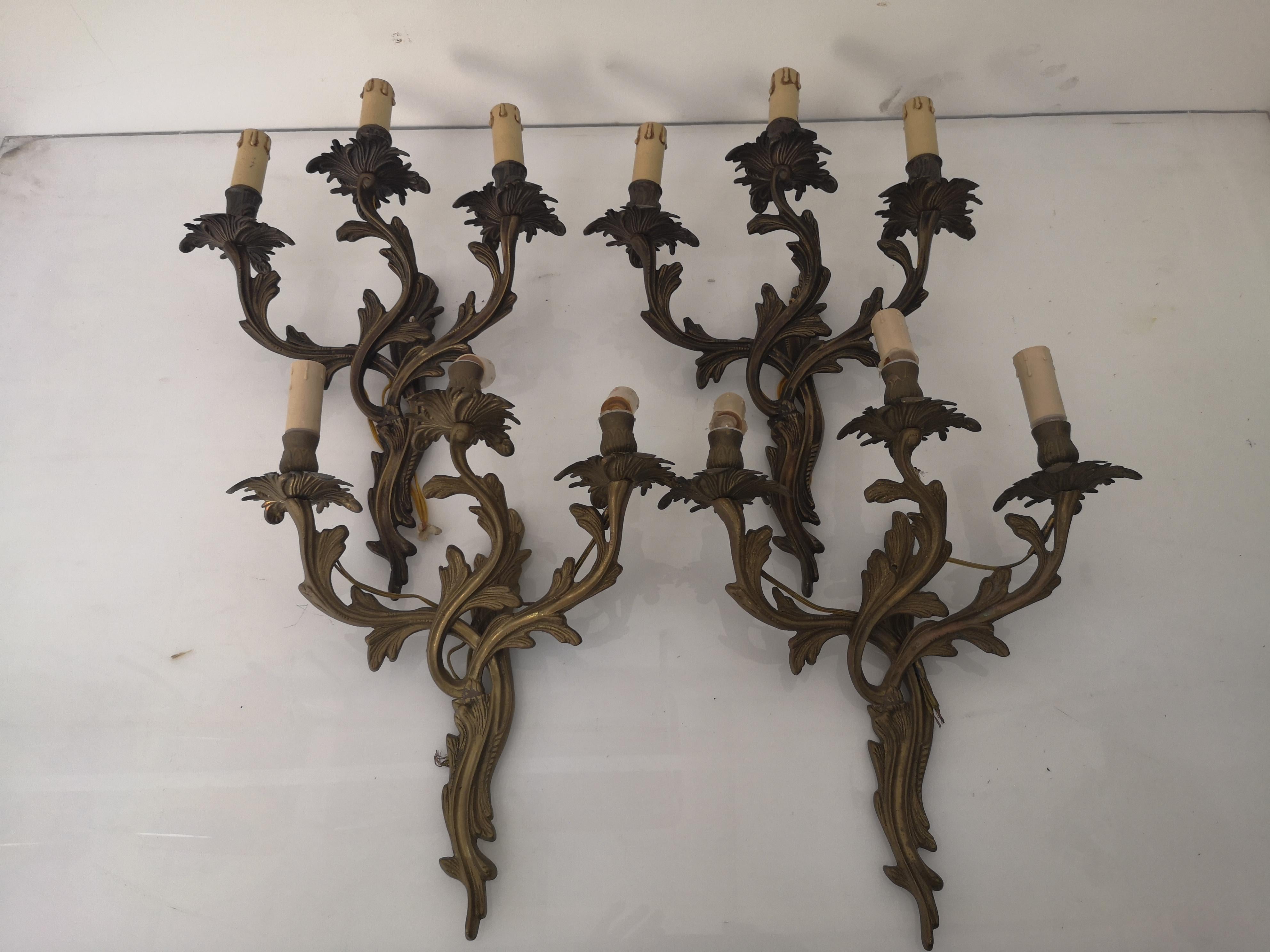 Set of 4 3-light bronze wall sconce in Louis XV style 1940s
The sconces are electrified, although the system is always best reviewed.
Measures: 
Height      cm 50
Width 30 cm
Depth 15 cm