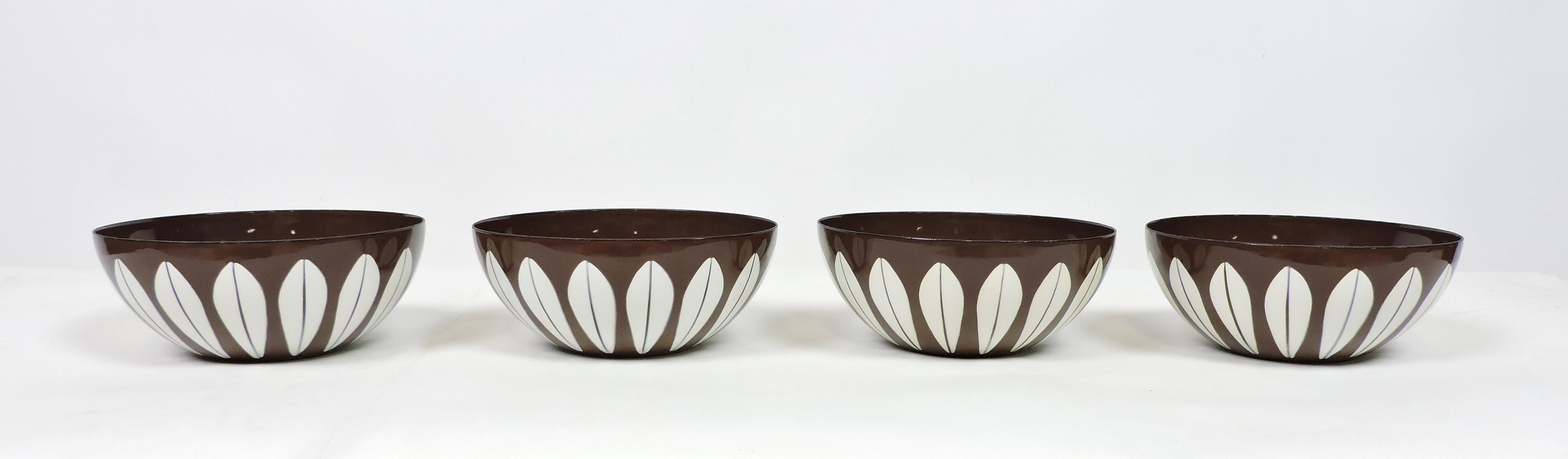 Very nice set of four enamel on metal bowls designed by Grete Prytz Kittelsen and Arne Clausen for Cathrineholm of Norway. These 5.5 inch diameter bowls have the white lotus design on a warm brown colored background. Marked on the bottoms,