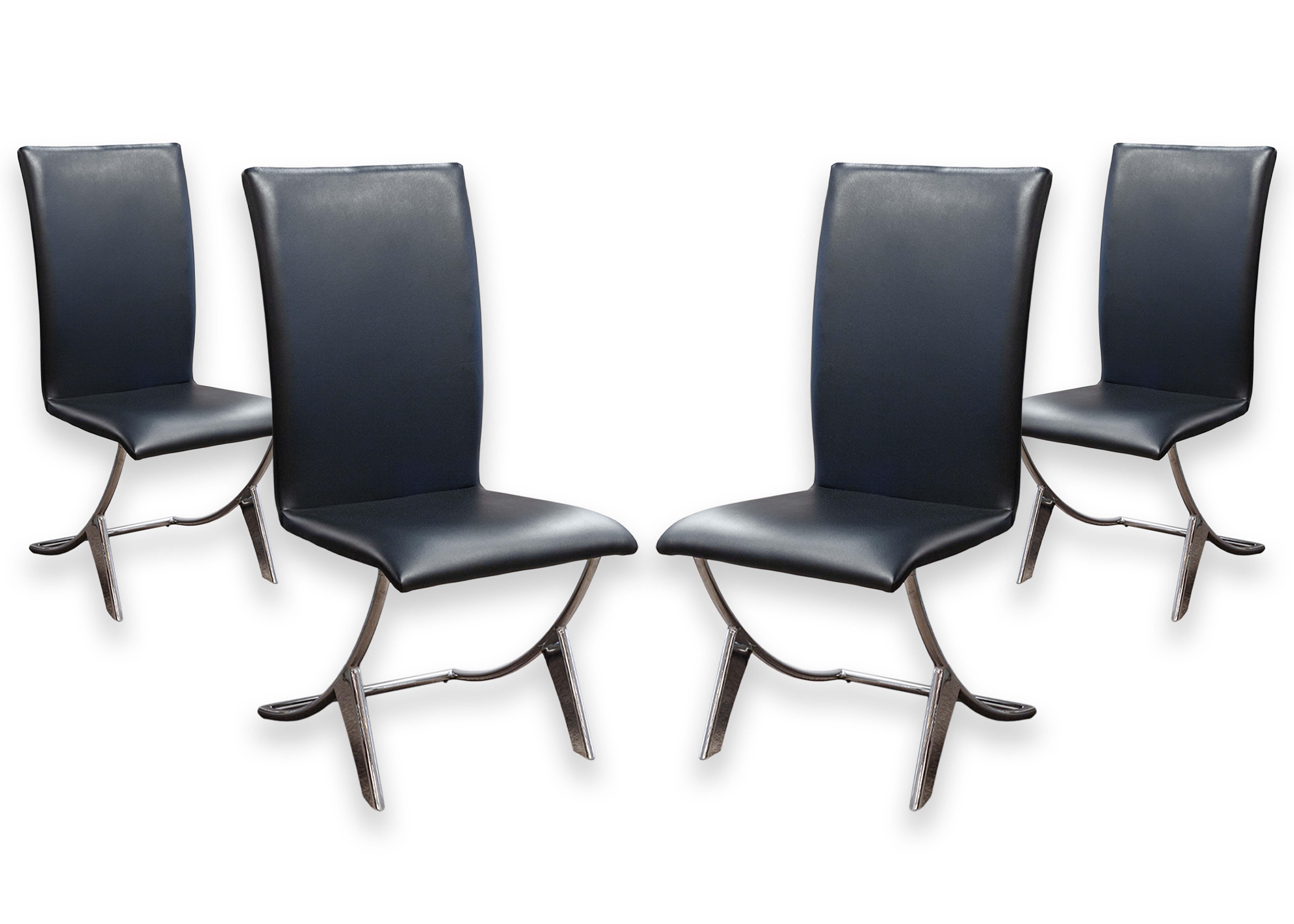 A set of 4 chrome and naugahyde dining chairs. This lovely set of dining chairs feature a super stunning contemporary modern design. The upper features a high back, armless naugahyde covered seat, and the base boasts a tubular chrome steel frame