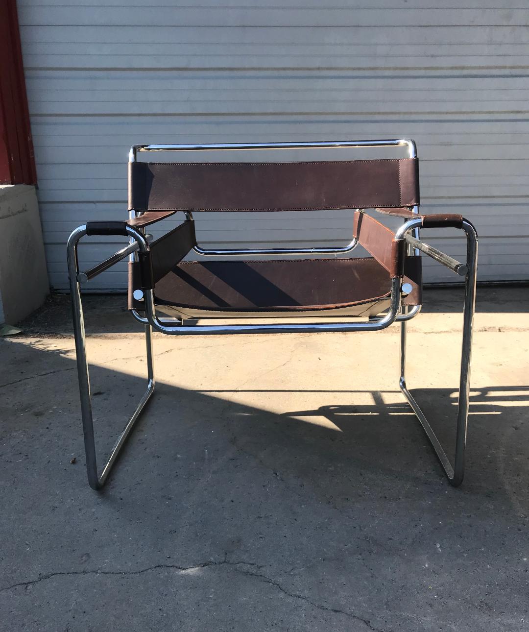 An iconic Marcel Breuer for Knoll Wassily chairs with tubular chrome frame and brown leather. No caps on the ends of the tubular frame. One continuous piece of metal.

Creator: Marcel Breuer for Knoll.
Date of manufacture: circa
