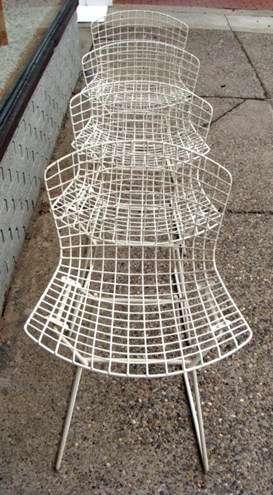 Set of 4 early production Knoll/ Harry Bertoia side chairs, circa 1955 in white. All original, great vintage condition. Very slight wear. Acquired from original owner. Seat pads long discarded but replacements are easily found online.
