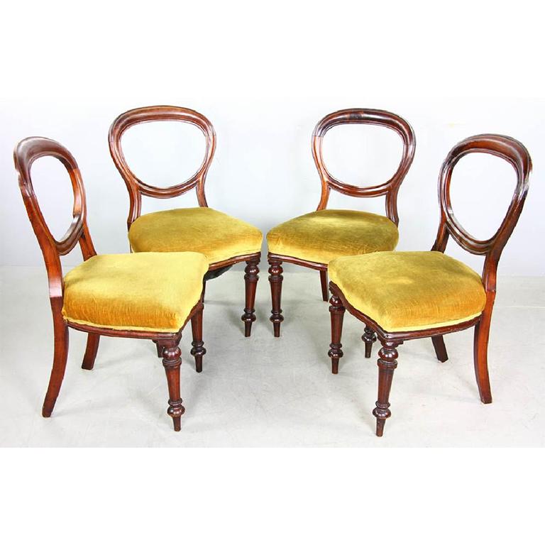 Set of four (4) Victorian style balloon back mahogany dining chairs from the 20th century.

Chairs feature rounded open balloon backs out of rich mahogany. Legs are mahogany as well, and feature turned legs fasted to an apron seat base. Atop the