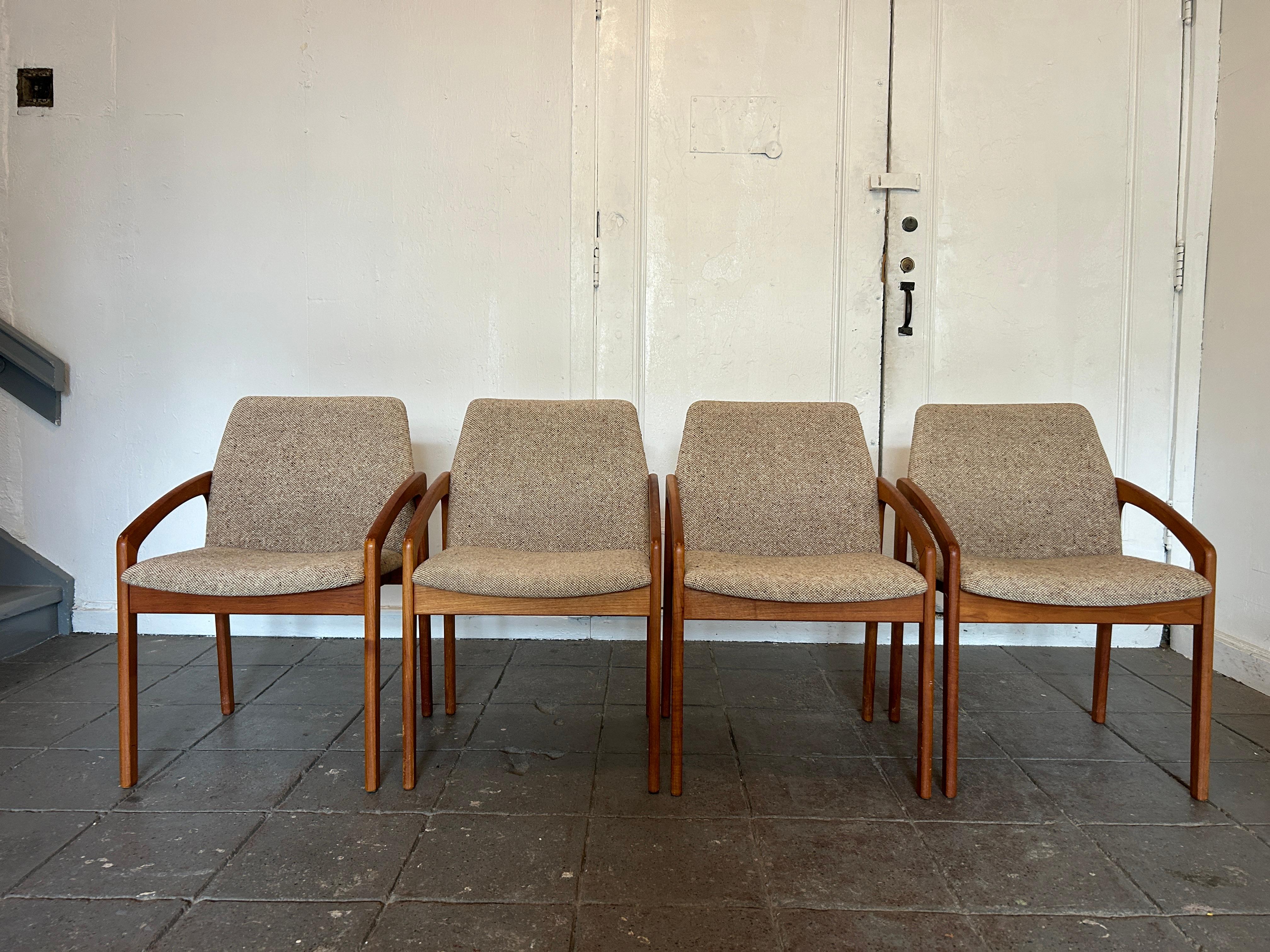 A set of (4) teak dining chairs by Danish master designer Kai Kristiansen for KS Mobler. These elegant chairs have solid teak frames with sweeping lines and very comfortable curved upholstered seats and backs. The downward swoop of the arms allow