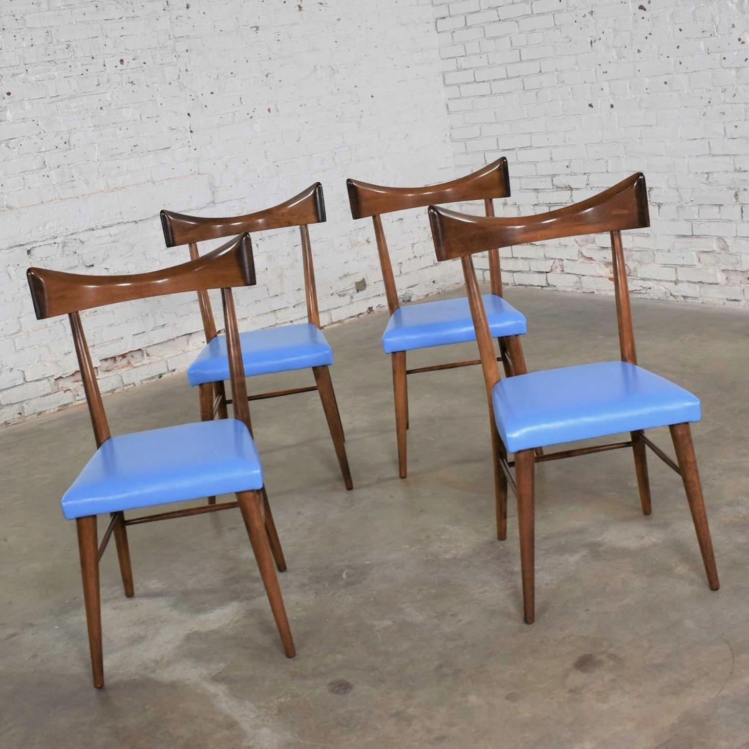 Handsome set of four Mid-Century Modern dining chairs #1534 for the Planner Group designed by Paul McCobb for Winchendon. They are in fabulous original vintage condition and wear their original bright blue vinyl upholstery on their foam seats. That