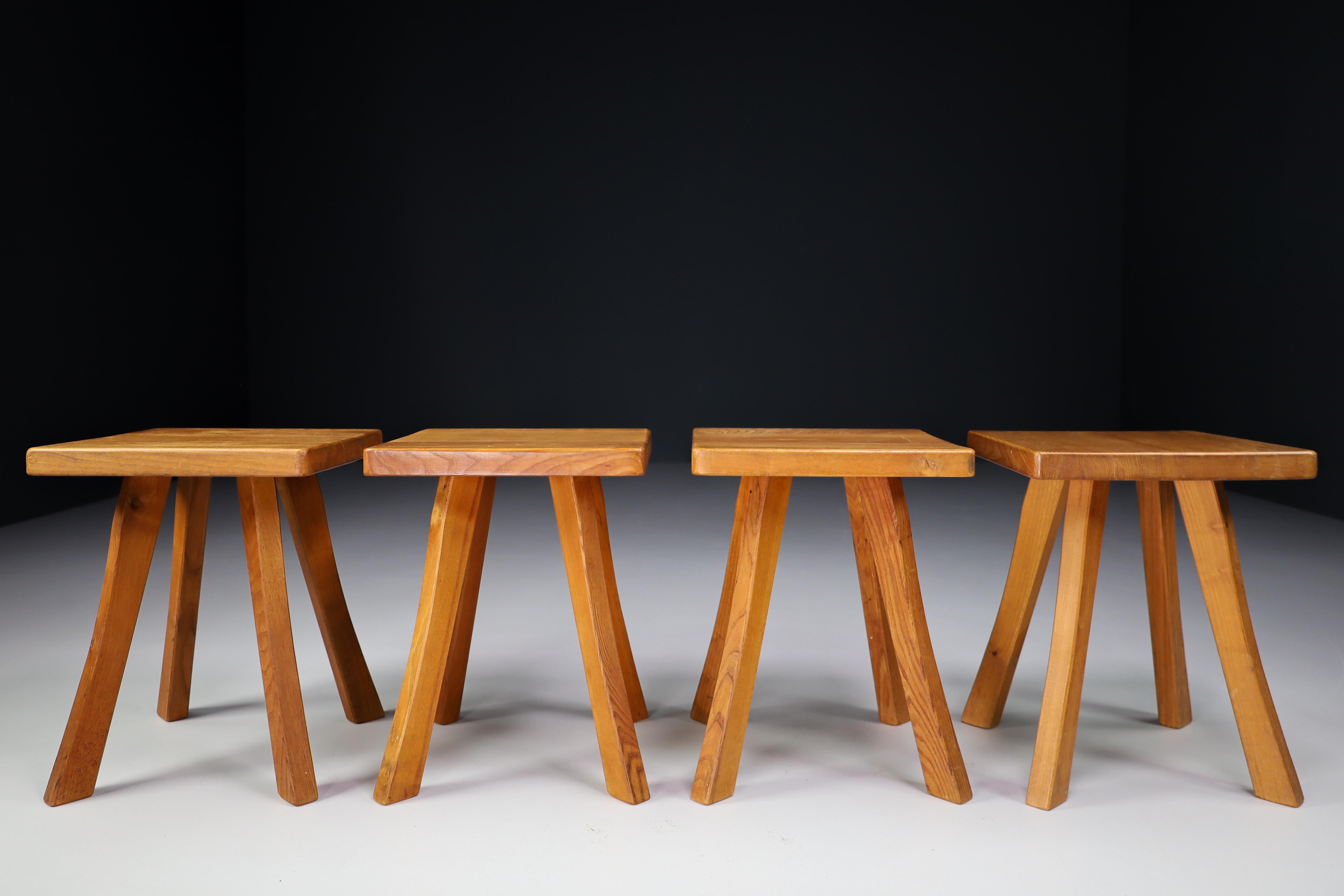 Set/4 of four-legged French stools in the style of Charlotte Perriand for the Les Arcs Ski resort and Pierre Chapo France 1950s. These solid elm stools shows an incredible patina and is in a very good original condition. These amazing stools would