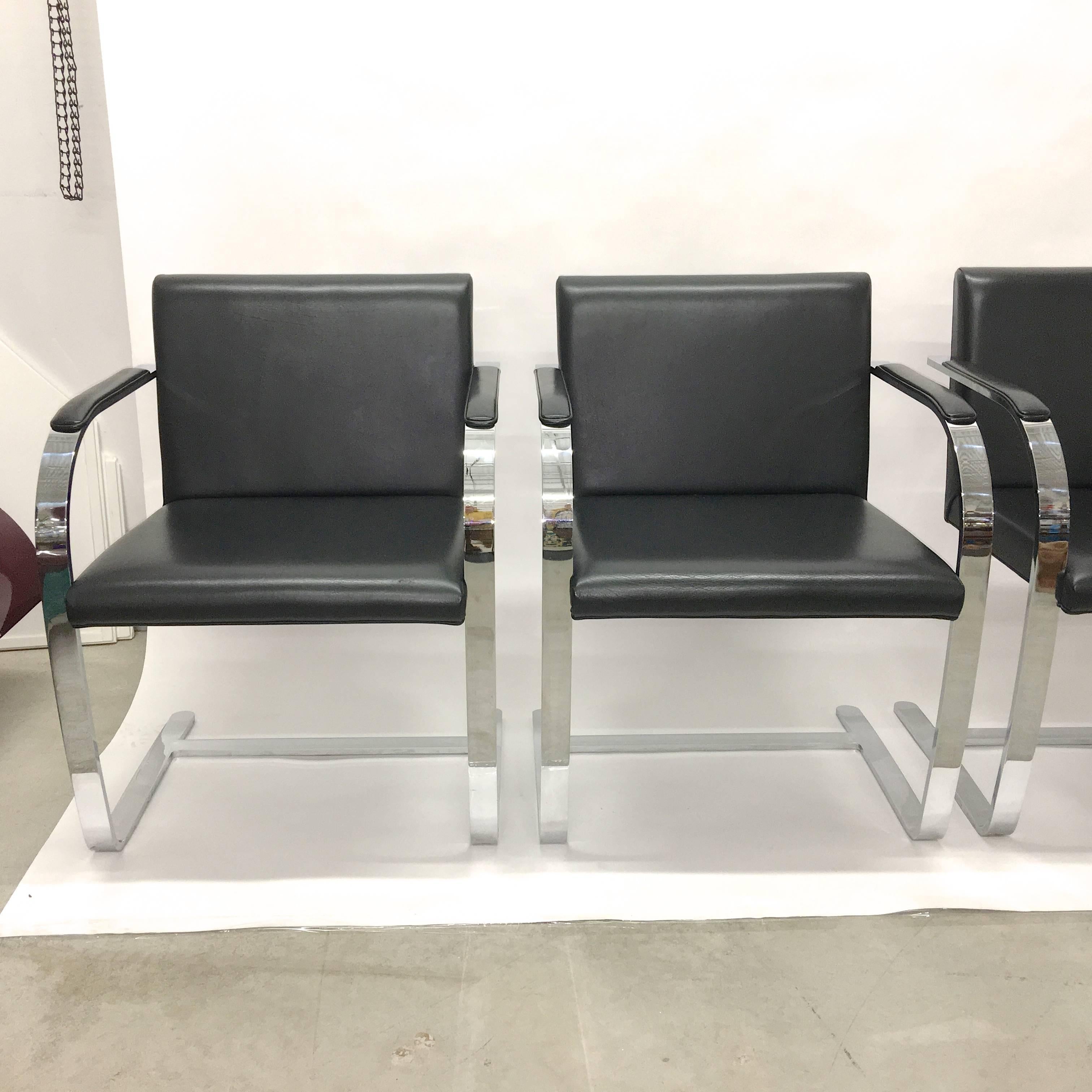 Set of four Brno chairs with flat bar polished chromed steel cantilevered frame and black leather upholstered seats and arm pads.

These were produced by Knoll in 2005 and appear to have been barely used at all.

Excellent condition.

Arm