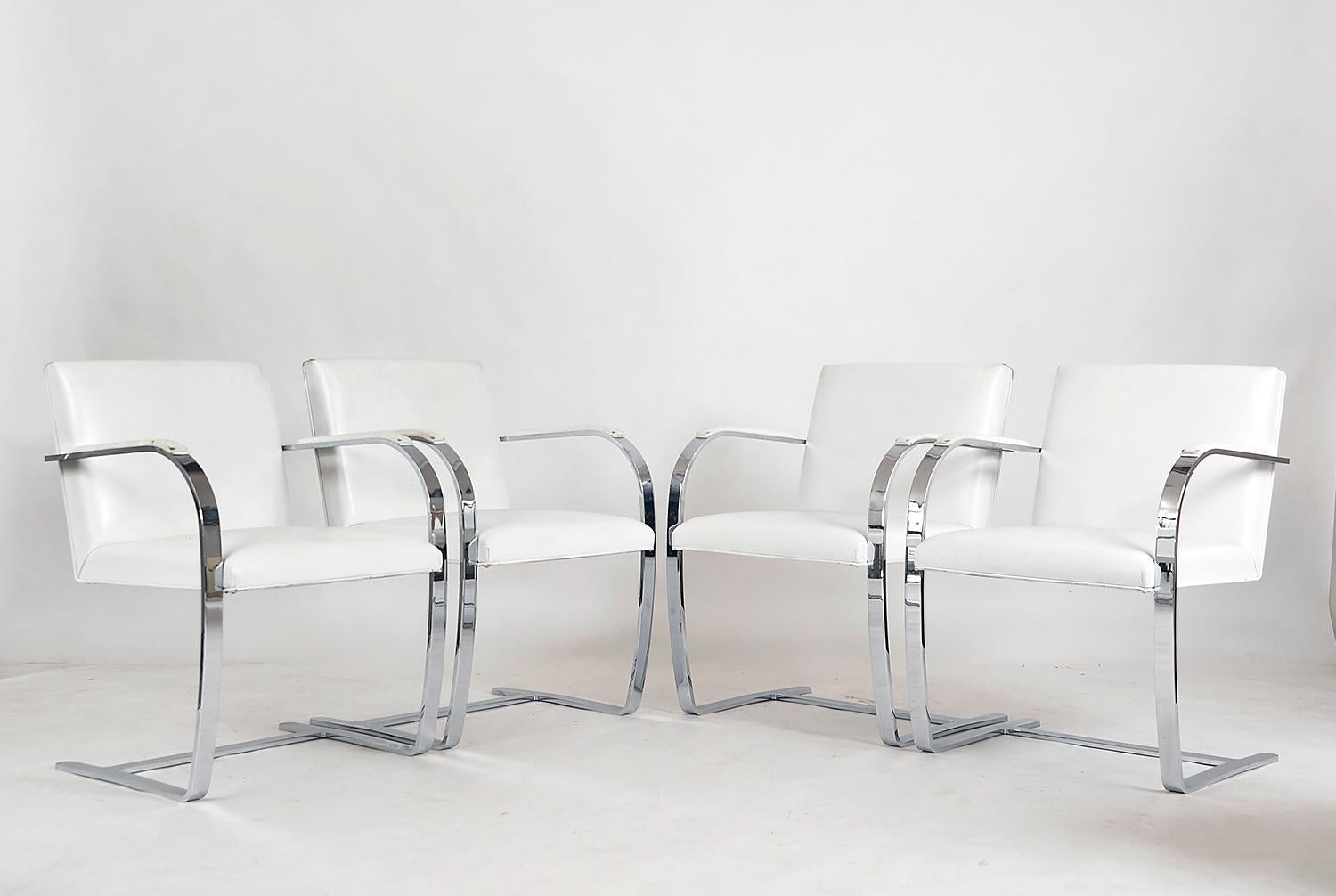 Celebrated for its lean profile and clean lines, the Brno chair was designed by Mies van der Rohe in the 1930s, and is an icon of 20th-century design. This is a rare opportunity to acquire a set of four vintage Brno dining chairs with a flat bar