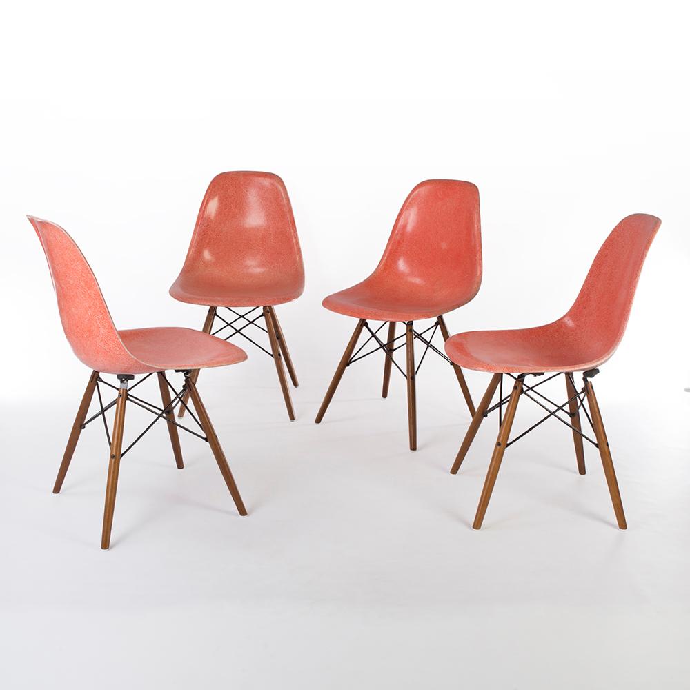 This a set of used, Zenith faded salmon Herman Miller Eames dining chairs- the shell has detailed fiberglass marks, attached to a natural oak wood dowel base to create a perfect dining chair.T here are some scratches on the surface, and water marks