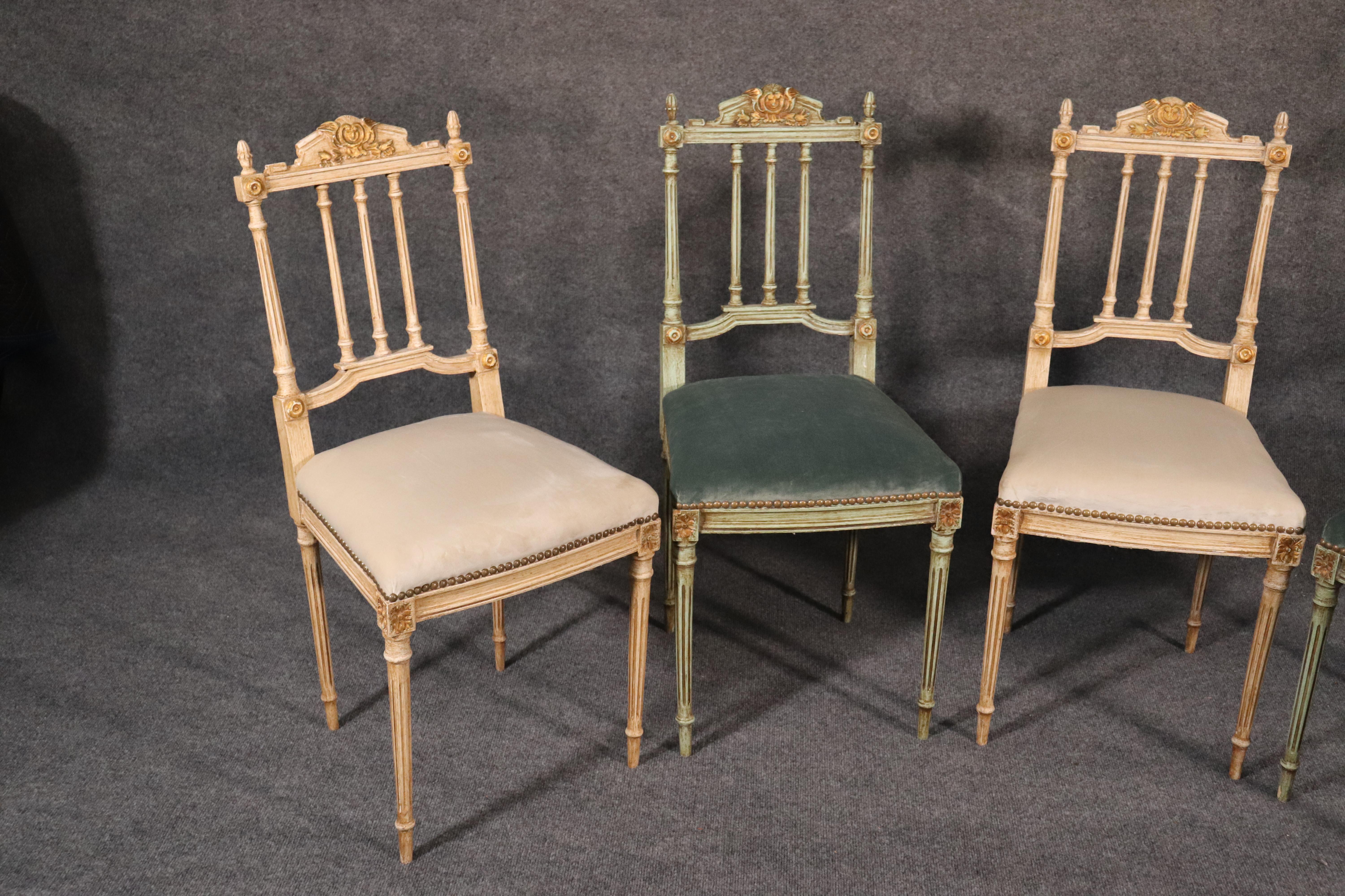This is a fine set of beautifully painted and gilded carved chairs. They are perfect for use as parlor chairs or as vanity or occasional chairs, circa 1890s. They are in excellent condition with beautiful chenille upholstery. The colors of crème and