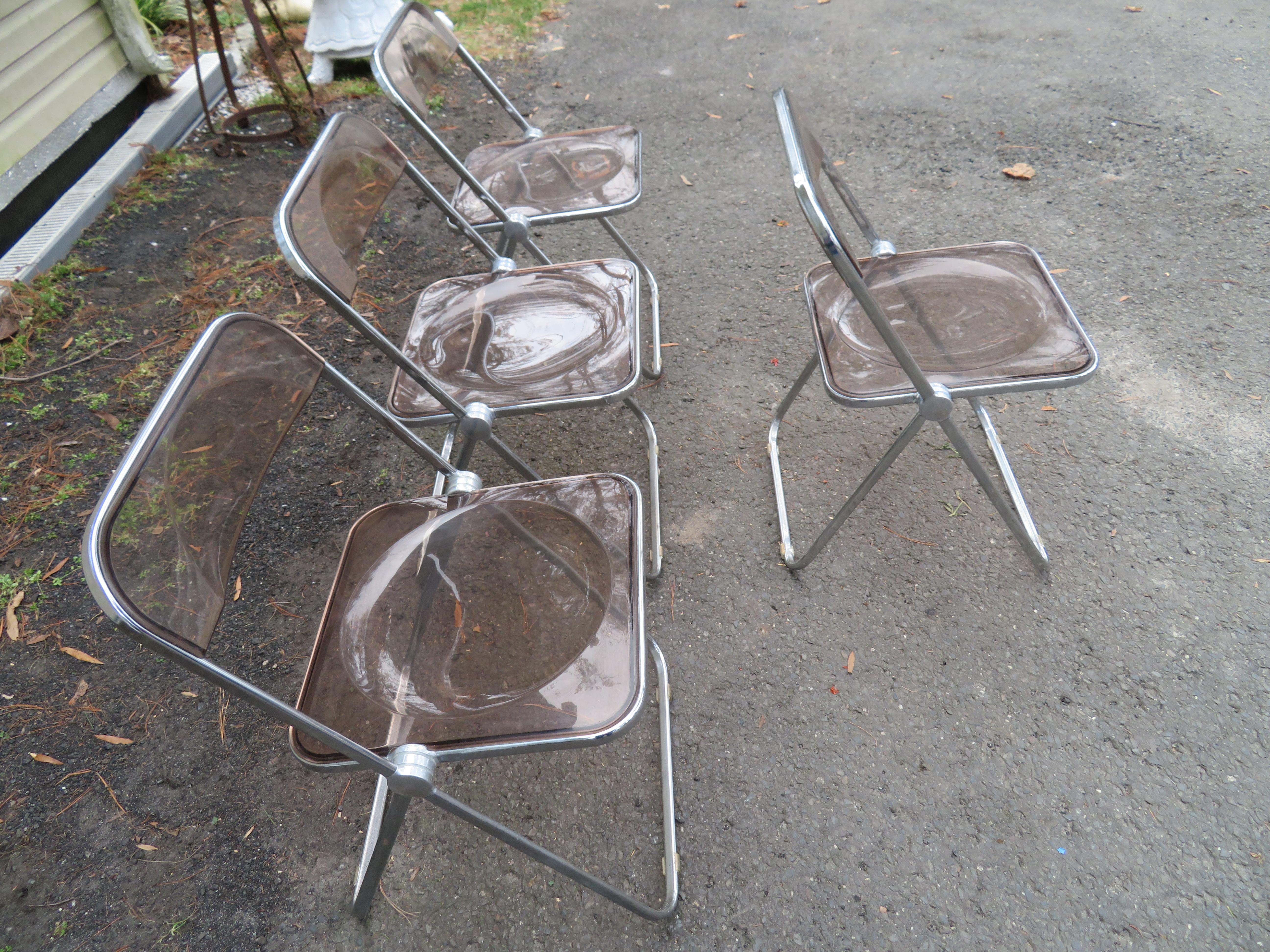 Wonderful set of 4 folding chairs, made of chrome and smoked Lucite, by Castelli, made in Italy for Krueger, circa 1960s. Chairs are in nice vintage condition. The dimensions are 18.5