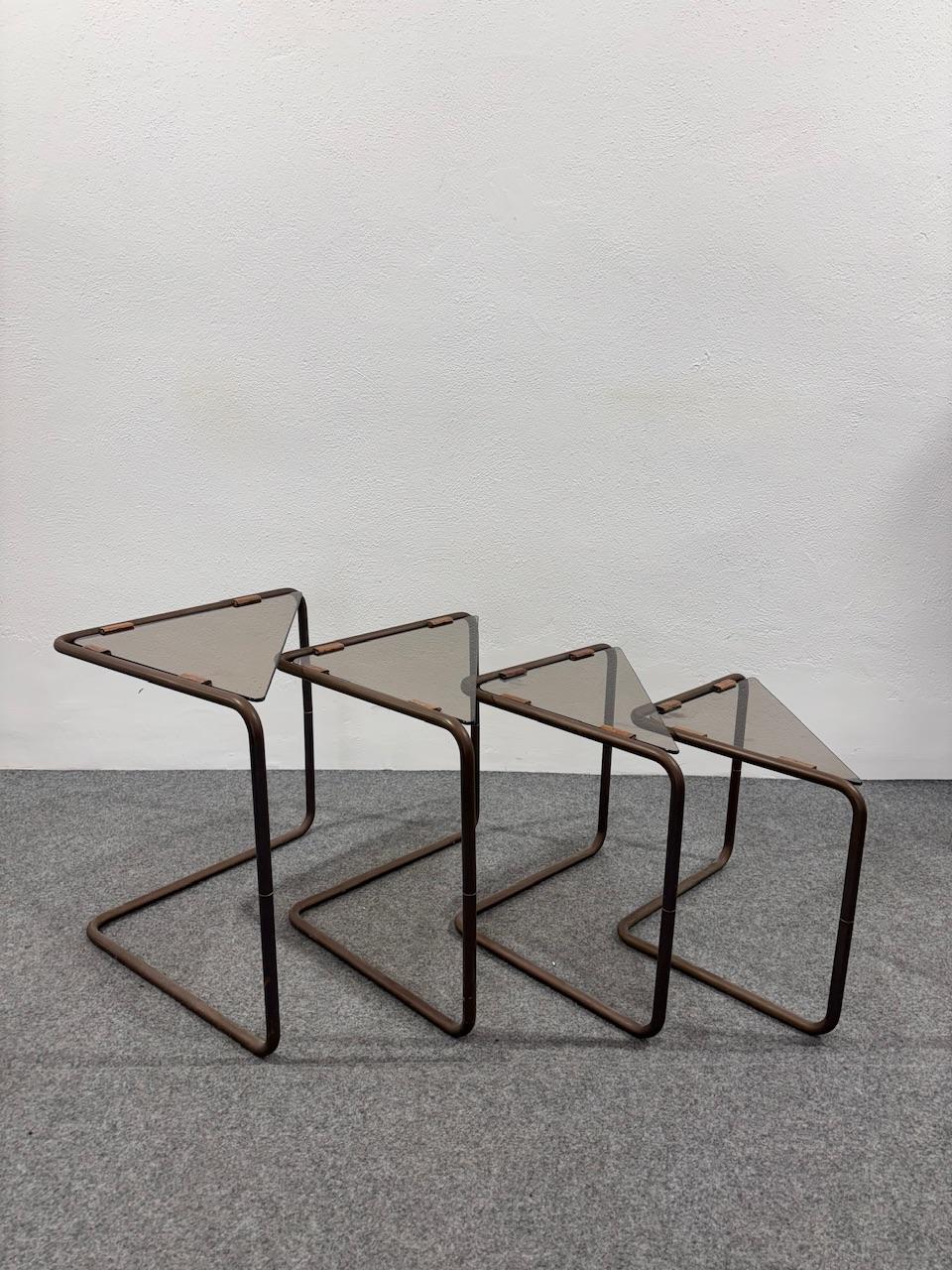 Wonderful set consisting of 4 side tables made entirely of bronze-colored metal and smoked crystal top.

The item is in good conservative condition, there are no cosmetic or structural defects to report, just slight and obvious signs of time due to