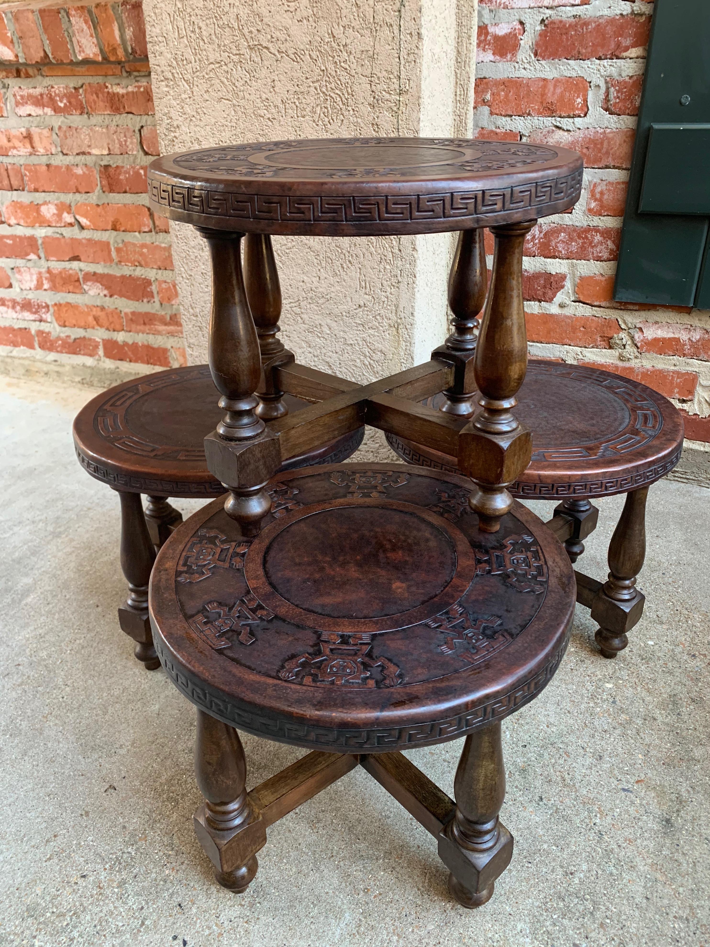 Direct from England, included in our latest container from the antique fairs near London, England, is this fantastic set of four short stools!~
~Gorgeous embossed leather, two of the stools have an embossed band of Aztec tribal warriors on the top