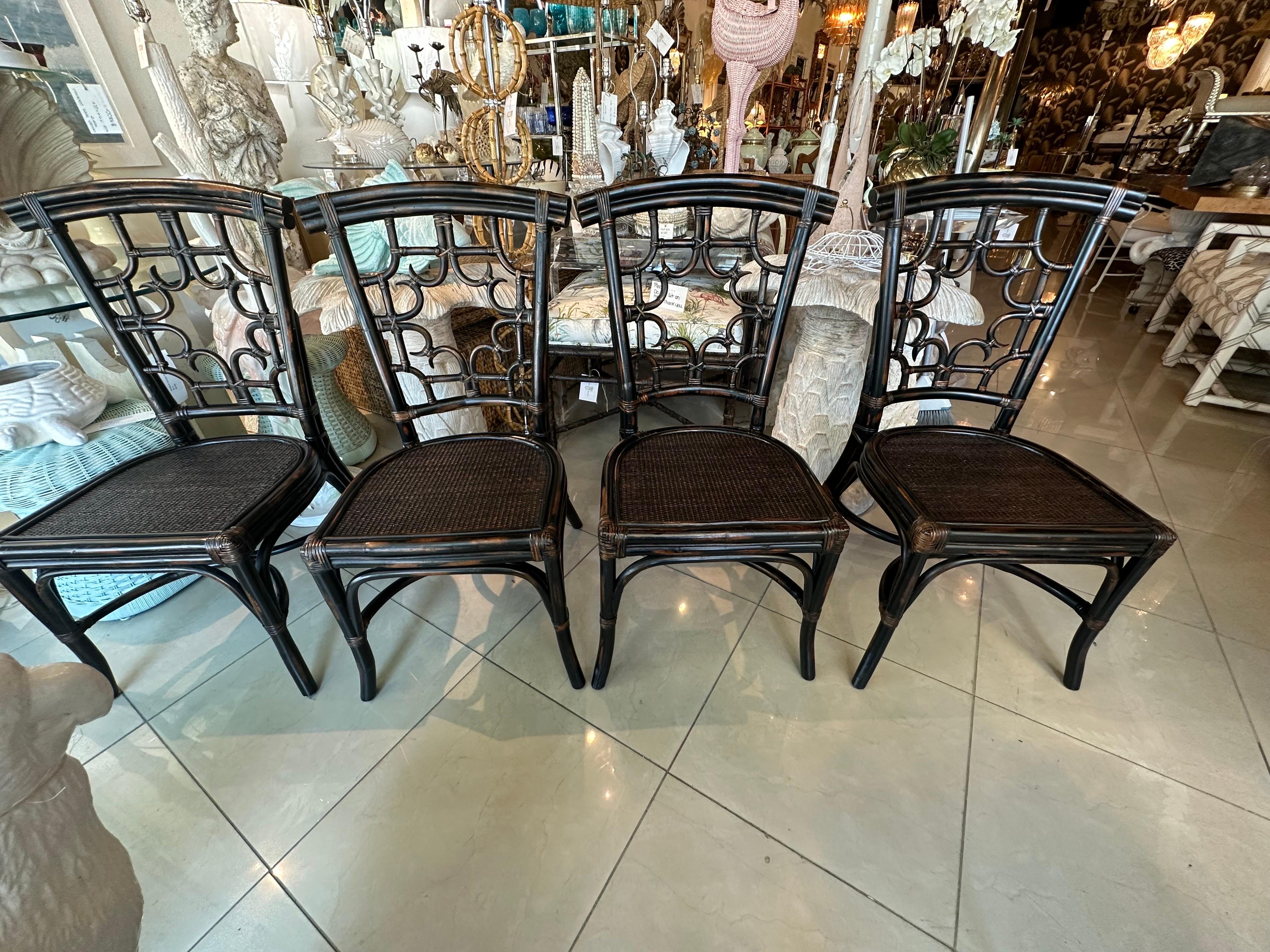 Vintage set of 4 fretwork fret work Chinese chippendale rattan, woven seats dining game side chairs. These are in excellent condition with no issues or damage. Original beautiful rattan with dark brown and black finish. Lovely details throughout.