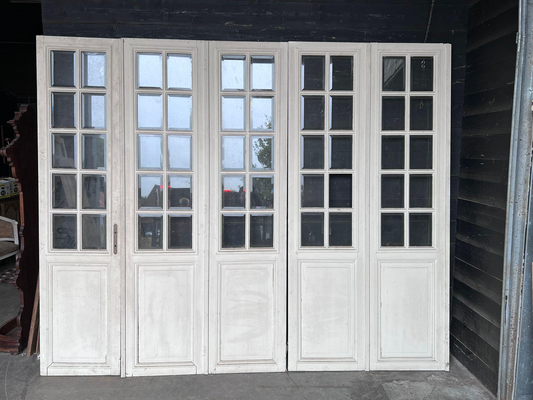 A lovely set of 5 French 19th century Chateau doors, from a Chateau in the Loire region. Having bevelled glass but note one square missing. The other side of the doors is brown.
Measures: height 275 cm
width 340 cm.