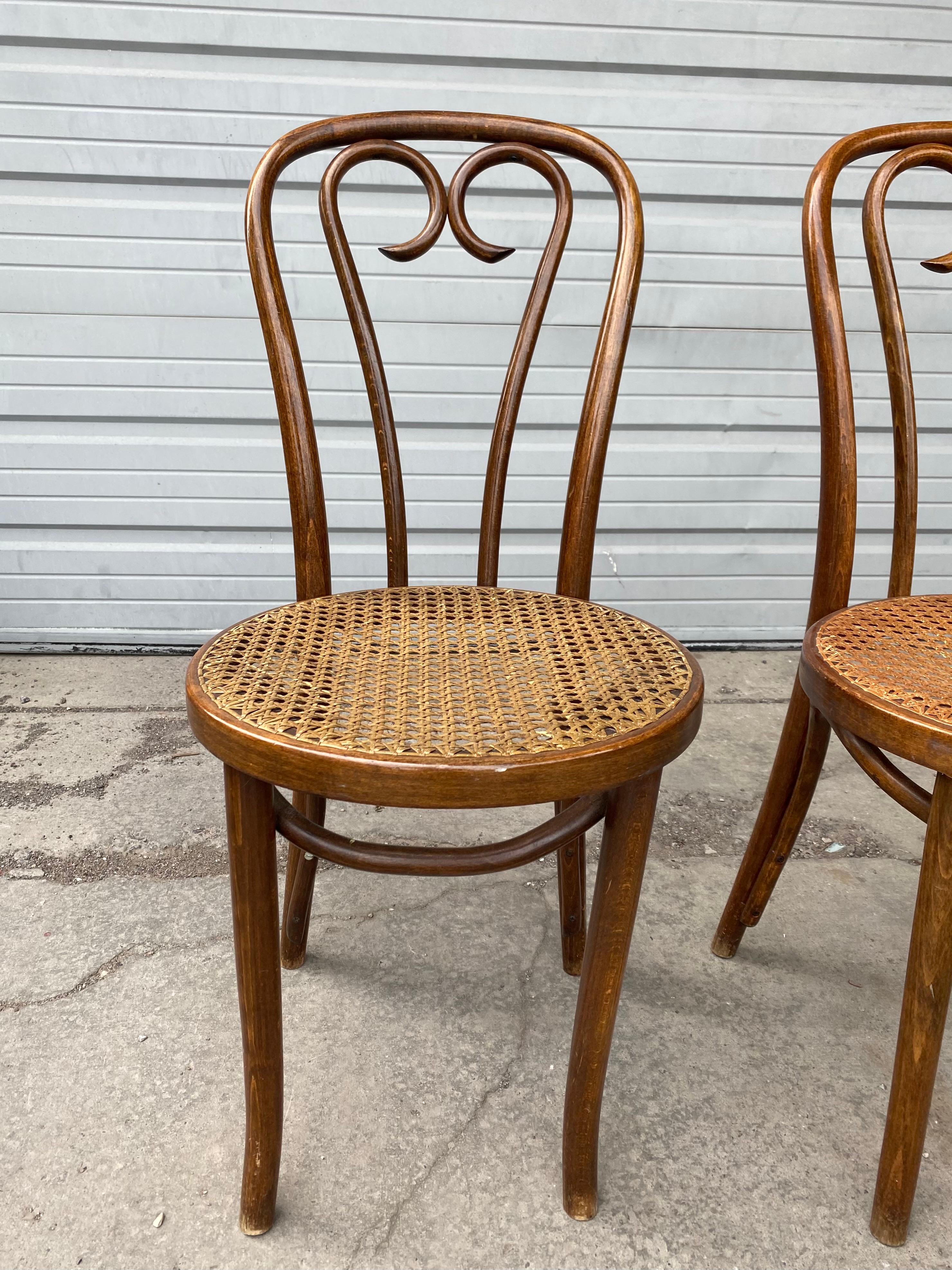 Classic bentwood cafe chairs. Price is for each chair. Chairs are all very tight and well-constructed, having been made in Romania during the sixties. Iconic design from Thonet which has lasted a century and a half. Crafted from beech, chairs are