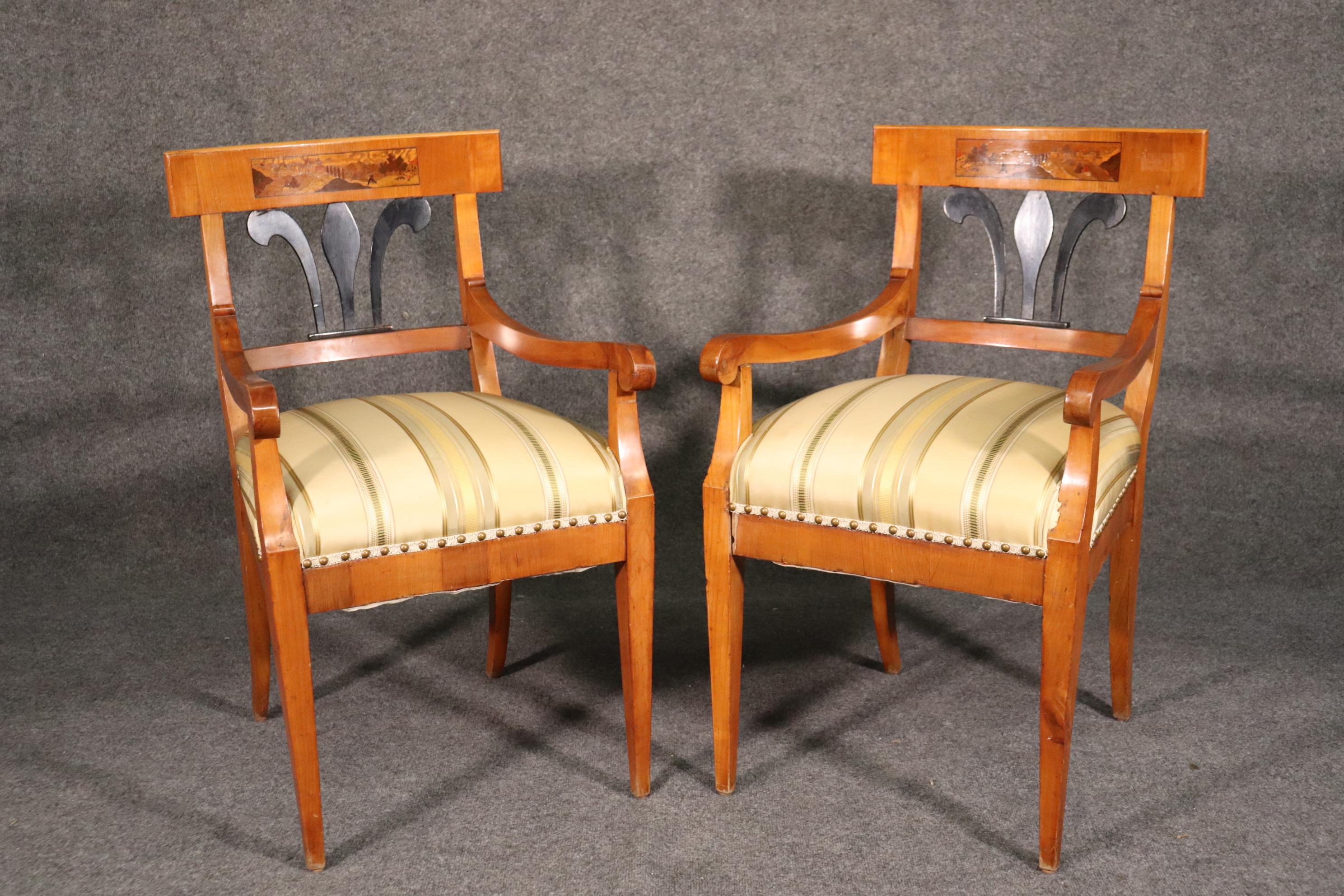 This is a gorgeous set of antique Biedermeier dining chairs with beautiful birch frames and ebonized details on the backs. The chairs are in good condition but will show some age cracks from years of use and are still usable and sound. The chairs