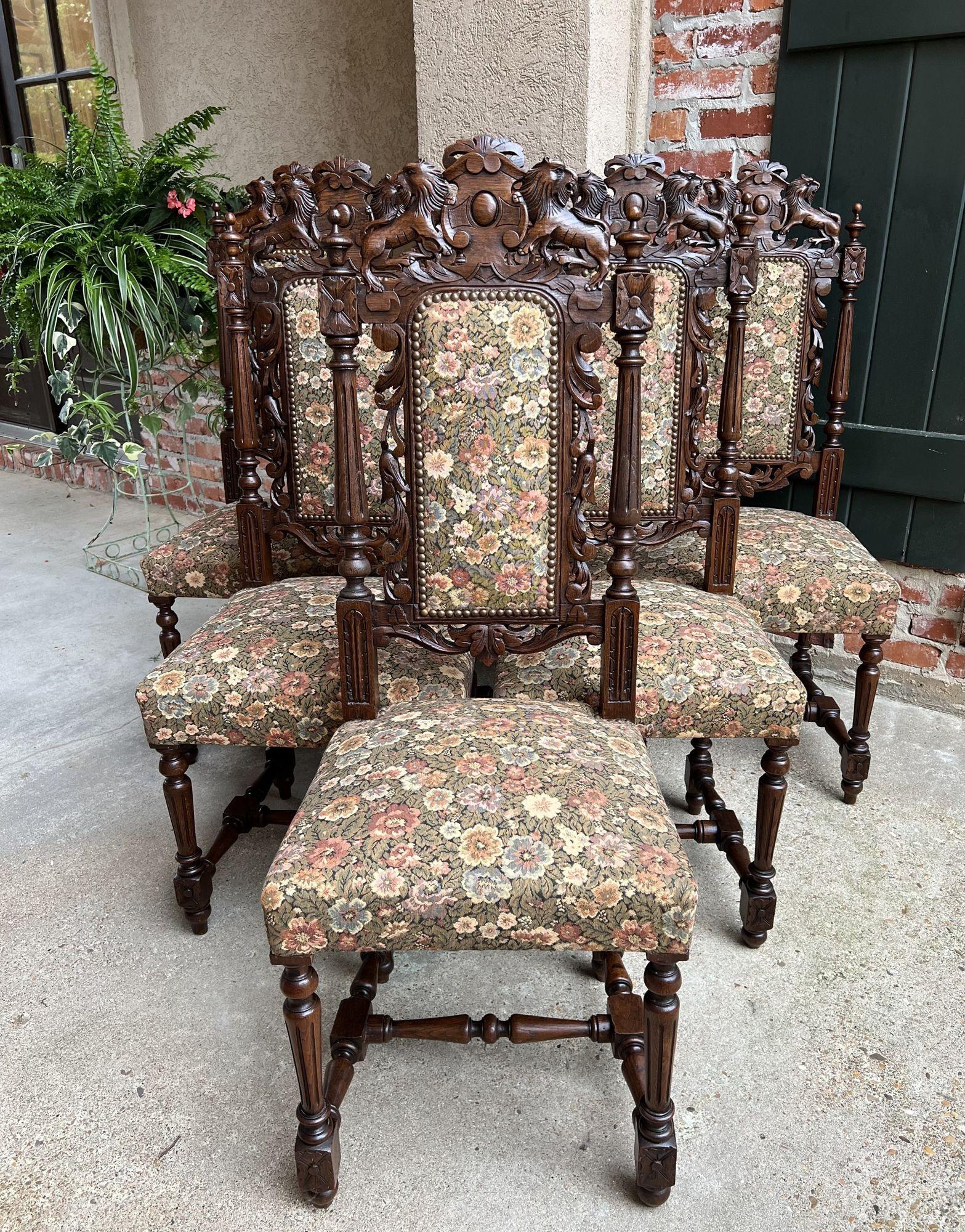 Set 6 antique French carved oak dining side chairs renaissance lion floral.
 
Direct from France, a gorgeous set of six antique French dining chairs. Ornately carved, with large crown featuring a center medallion flanked by rampant lions.
Large