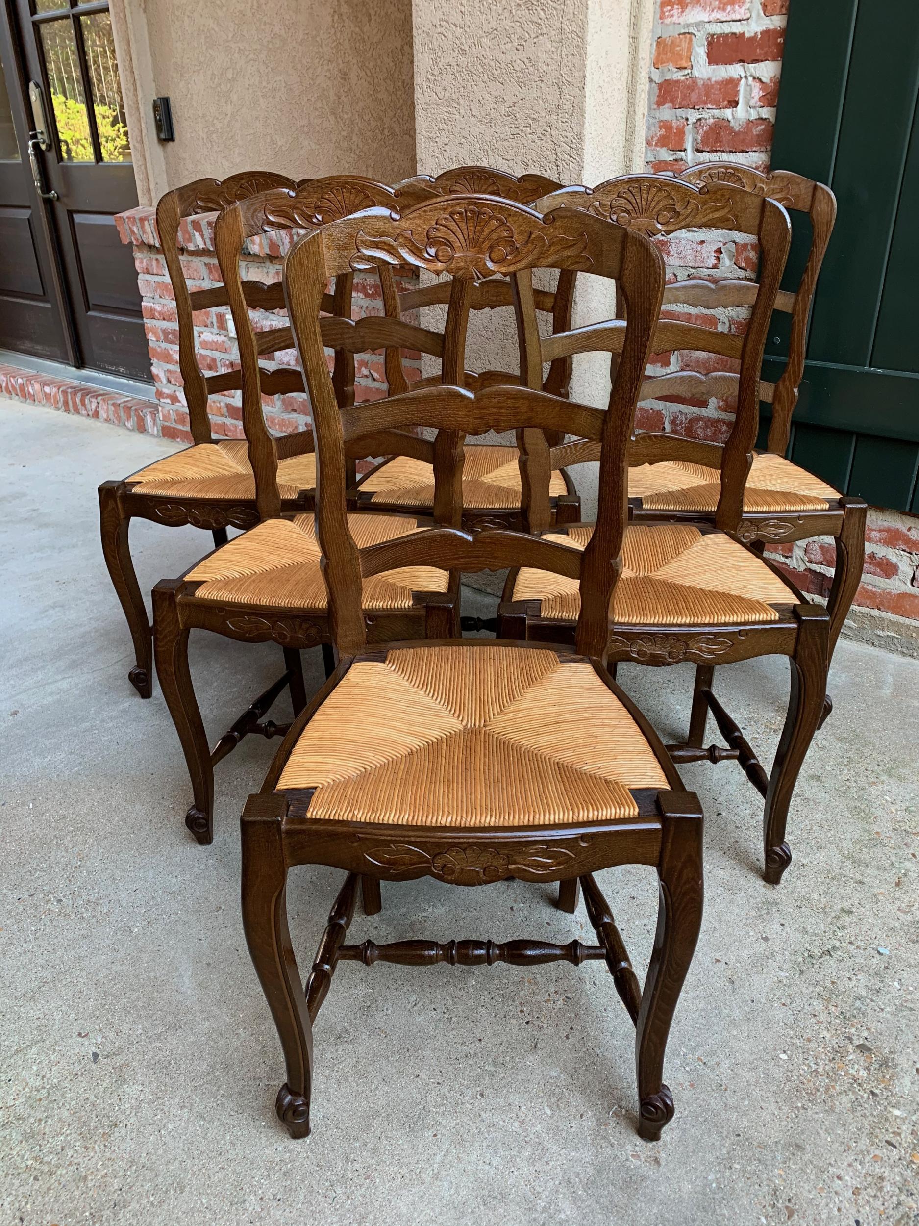 Set of 6 antique French country carved oak ladder back dining chair rush seat

~Direct from France~
~Lovely set of 6 antique French chairs, with classic French style… perfect for a kitchen or dining room with their original finish that