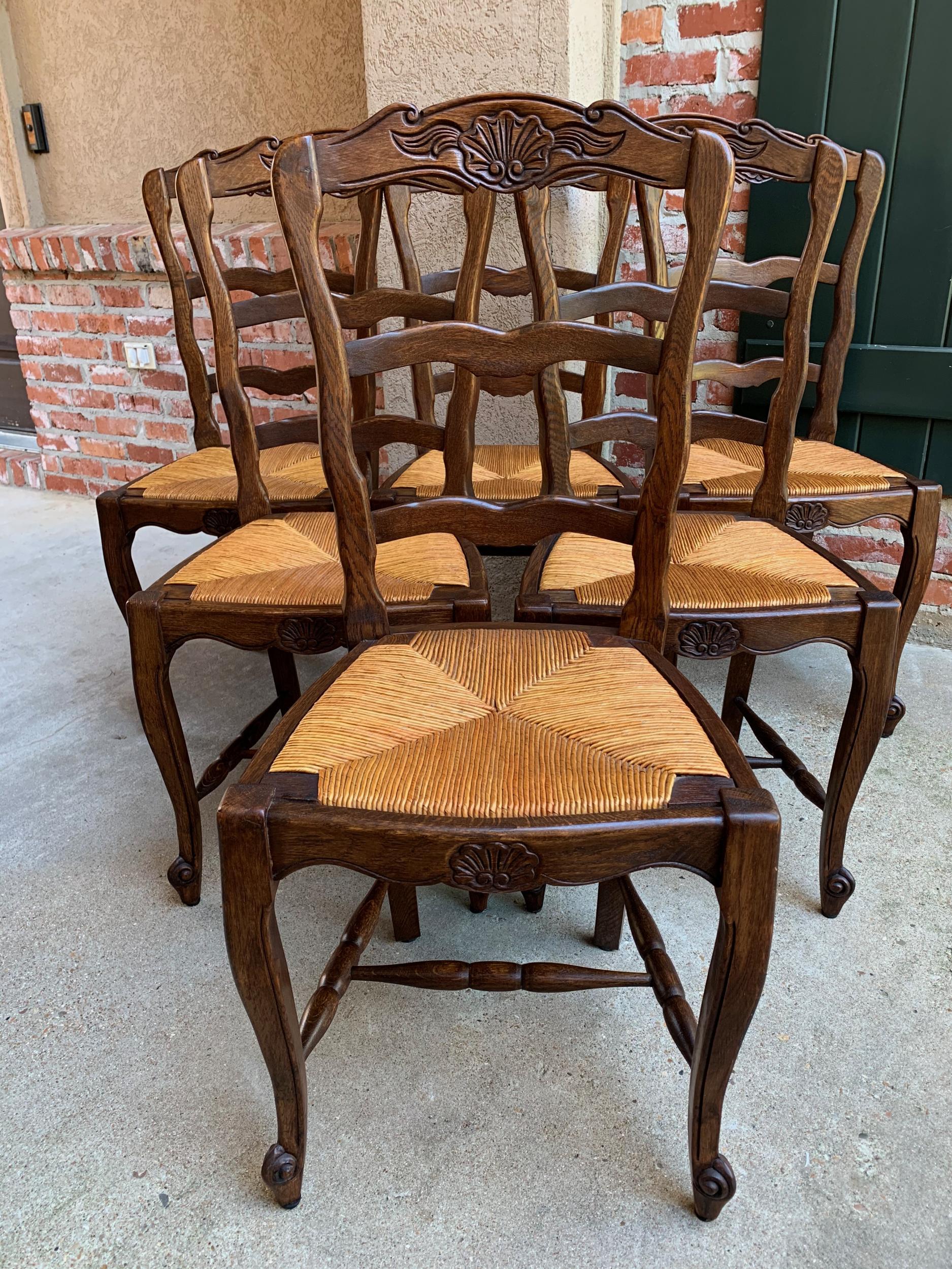 Set 6 antique French country carved oak ladder back dining chair rush seat

~Direct from France~
~Lovely set of 6 antique French chairs, with classic French style… perfect for a kitchen or dining room with their original finish that compliments