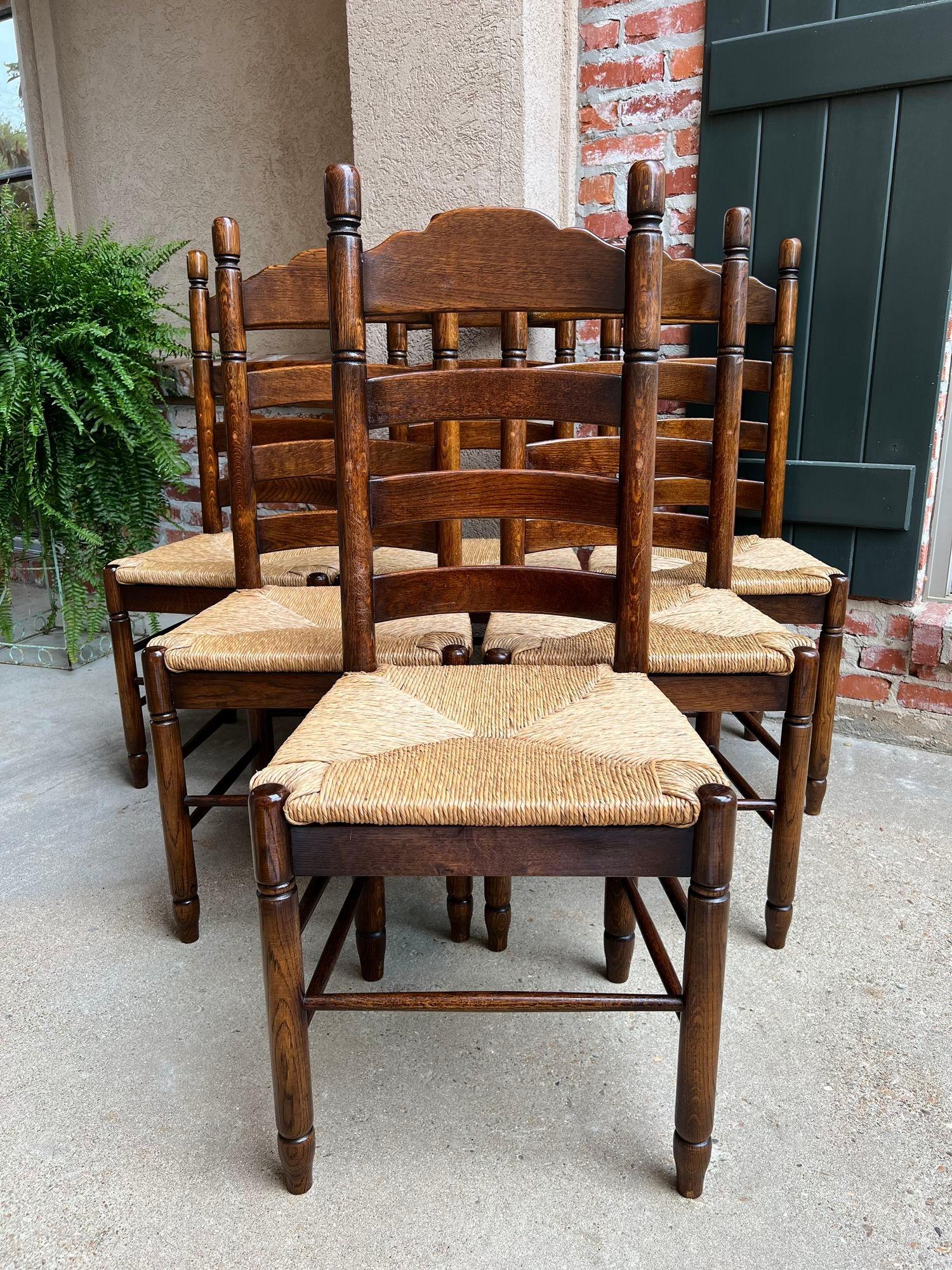 Set 6 antique French ladder back dining chairs carved oak rush seat country.

Direct from France, a lovely set of 6 antique French chairs, perfect for either a dining room or kitchen with their Classic French Country charm. The chairs have a