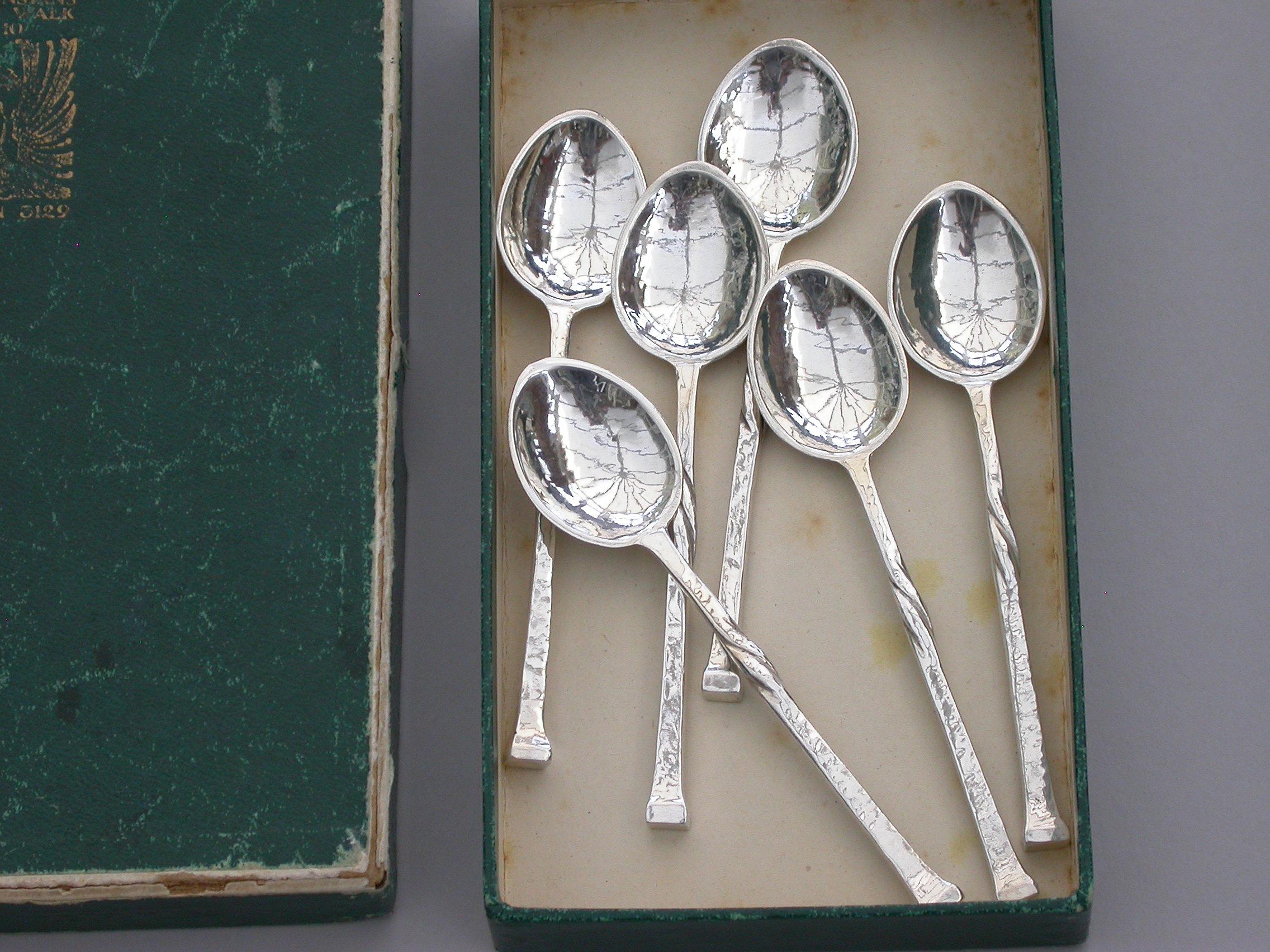 A good set of six early 20th century hammered silver coffee spoons made in the Arts & Crafts style with twisted tapering stems and nailhead finials. Complete with a green card Omar Ramsden box.

By Omar Ramsden, London, 1937-1939

88 grams total