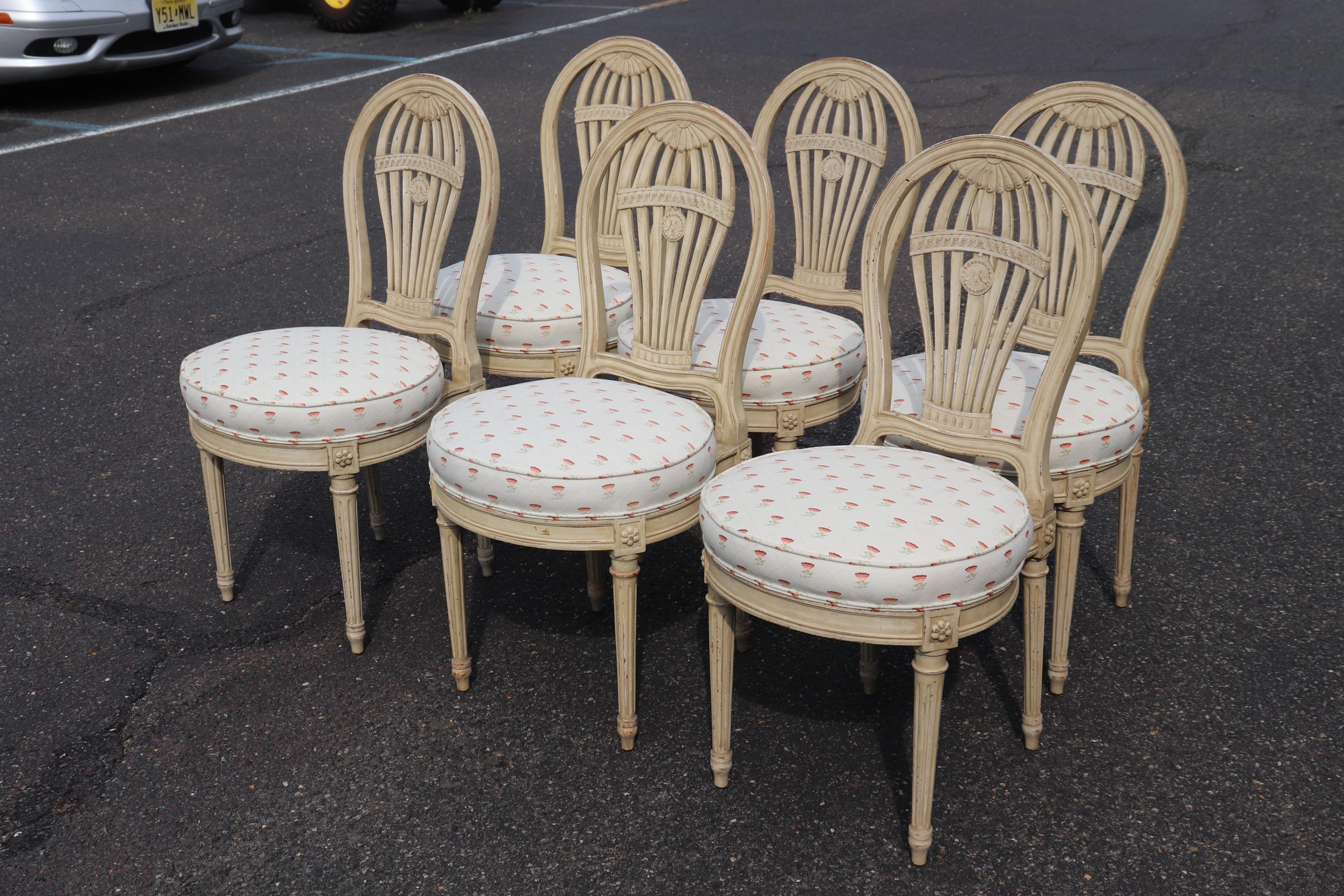 This is a gorgeous set of signed Maison Jansen dining chairs in antique white in good condition. The upholstery and the finish are in good condition with no major issues of any kind. The chairs date to the 1940s and measure 36 tall x 22 wide x 18