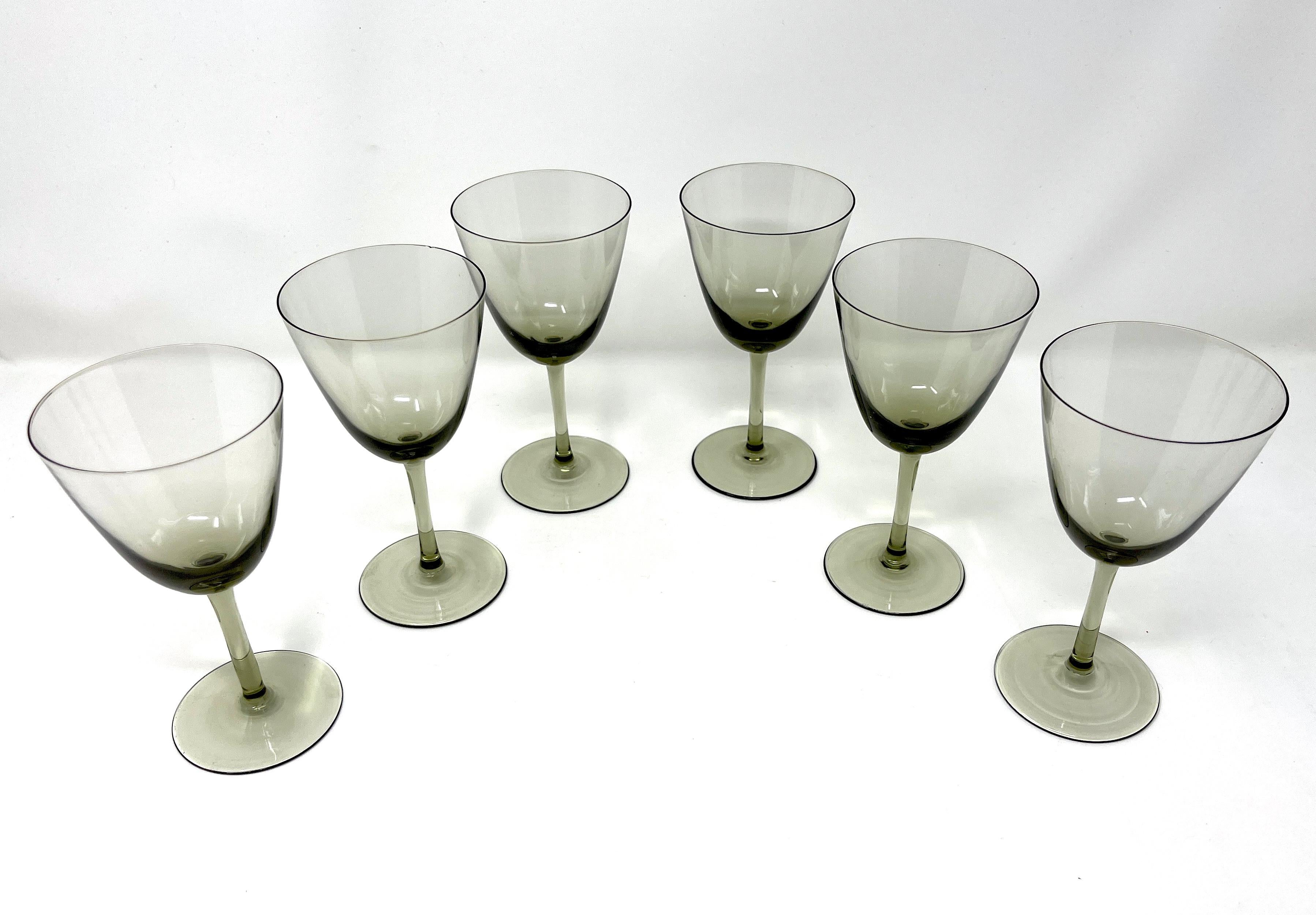 Set of 6 stunning smoke gray stemmed Danish Modern aperitif glasses. There are no markings, but these feel completely like Danish Modern art glass, handblown, and possibly by Holmegaard. Really gorgeous, sleek and artistic with a very thin top edge.
