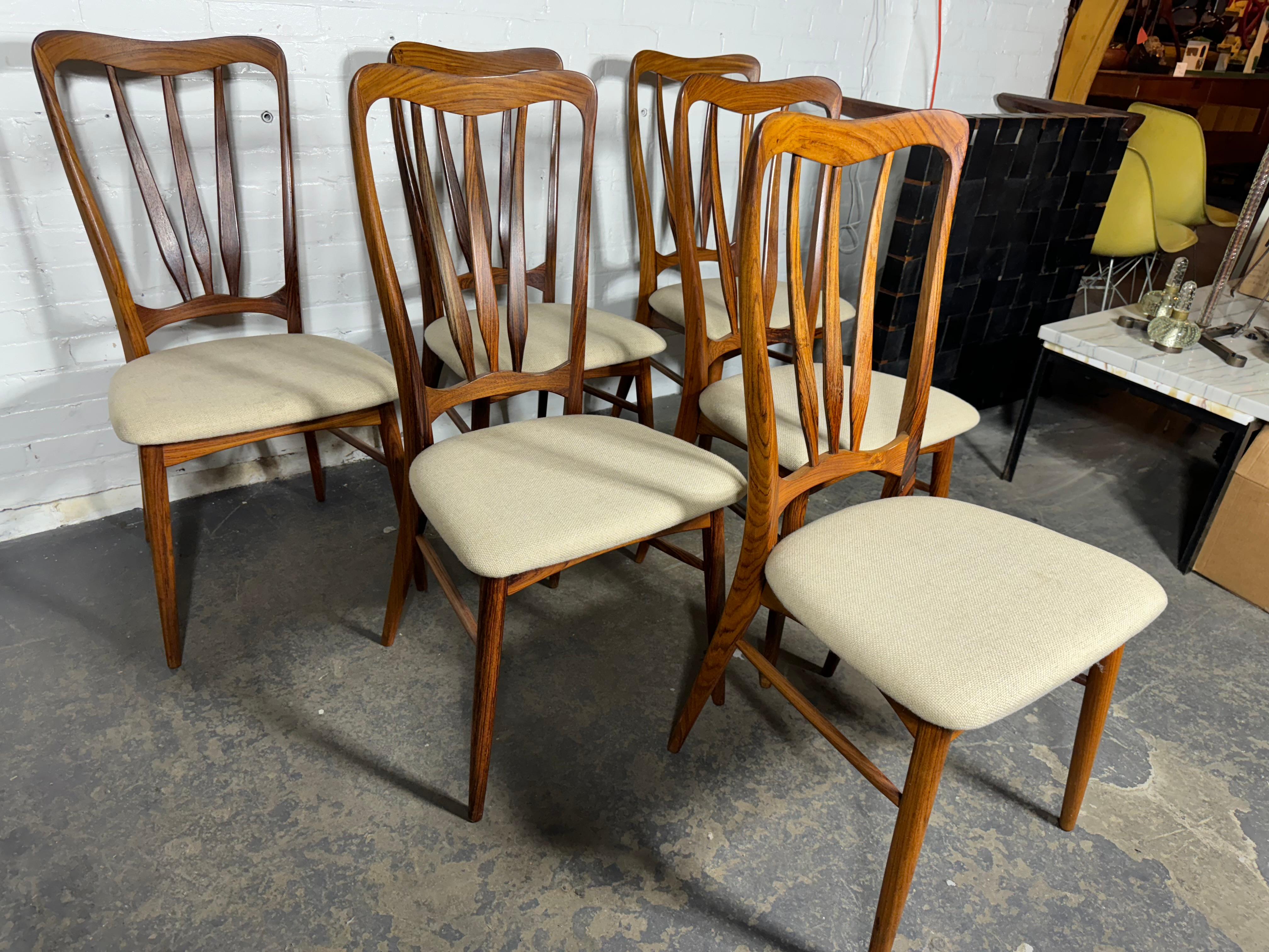 Set of six, Danish modern, rosewood, “Ingrid” dining chairs by Niels Koefoed for Koefoeds Hornslet .consists of 6 side chairs . The curvaceous frames feature high backs with a deep rosewood grain throughout and subtle joinery details that make these